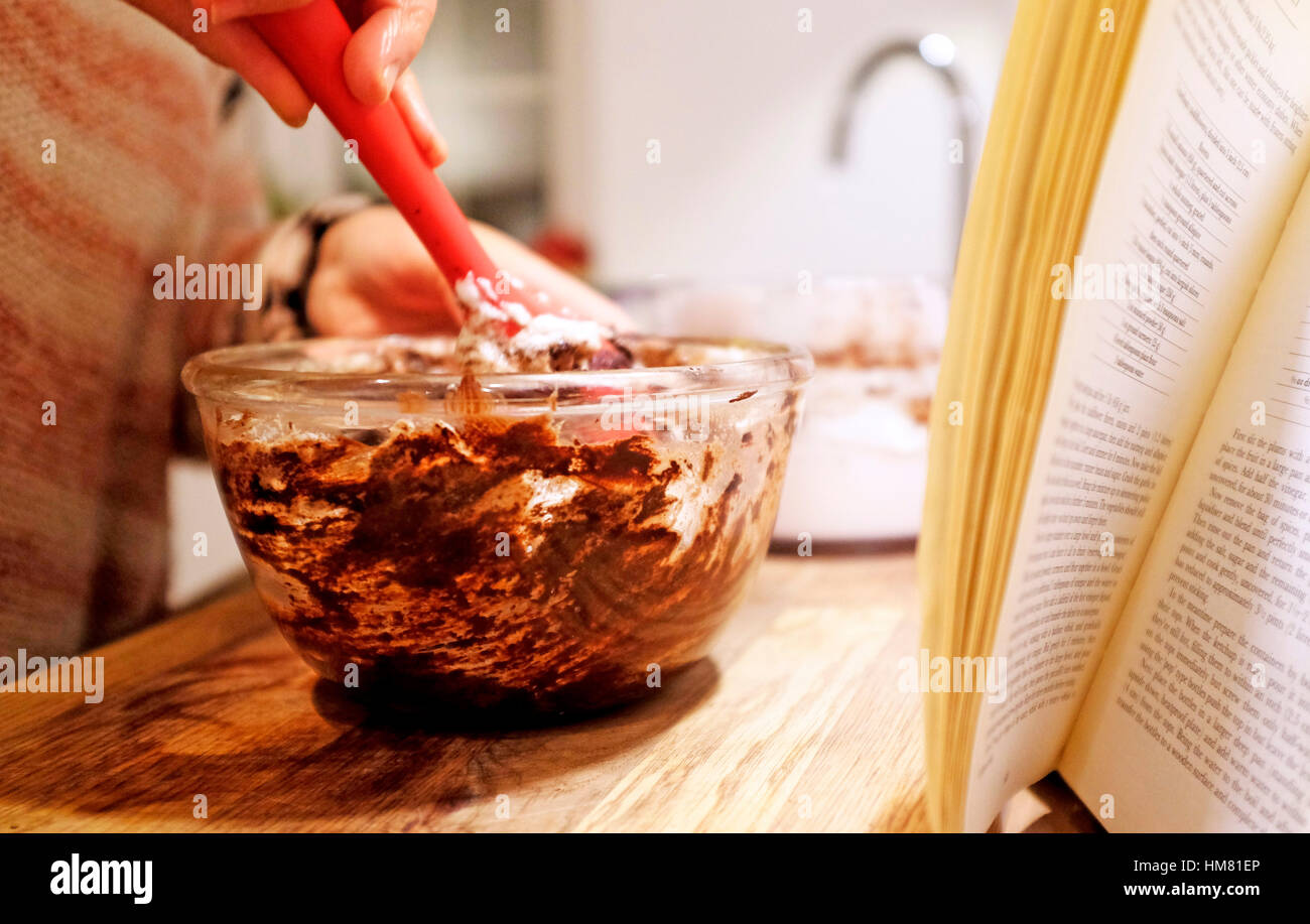 Cook mixing in by hand stiffened egg whites to melted chocolate to make