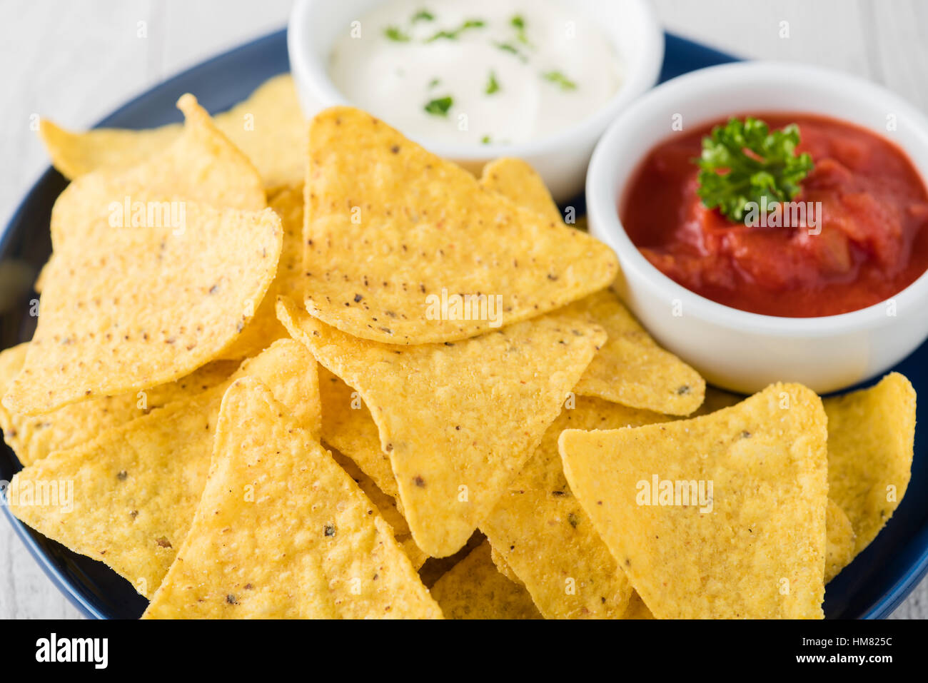 Nachos with salsa and sour cream dips Stock Photo Alamy