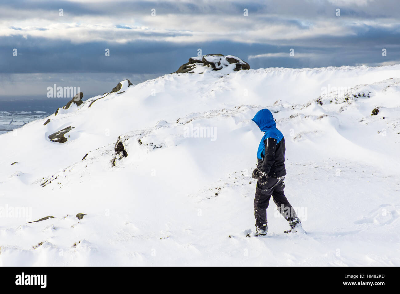 A male hill walker on Kinder Scout in winter, Peak District National Park Stock Photo