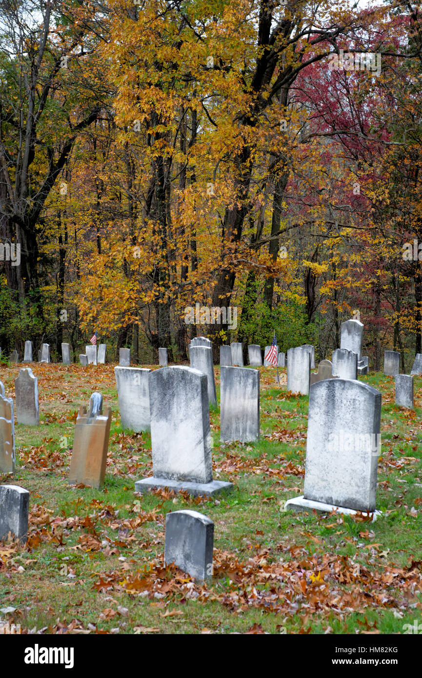 Old cemetery full of weathered headstones and old tombstones with fall ...