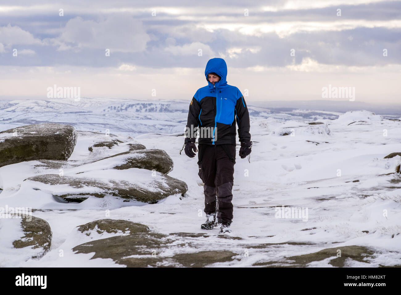 A male hill walker on Kinder Scout in winter, Peak District National Park Stock Photo