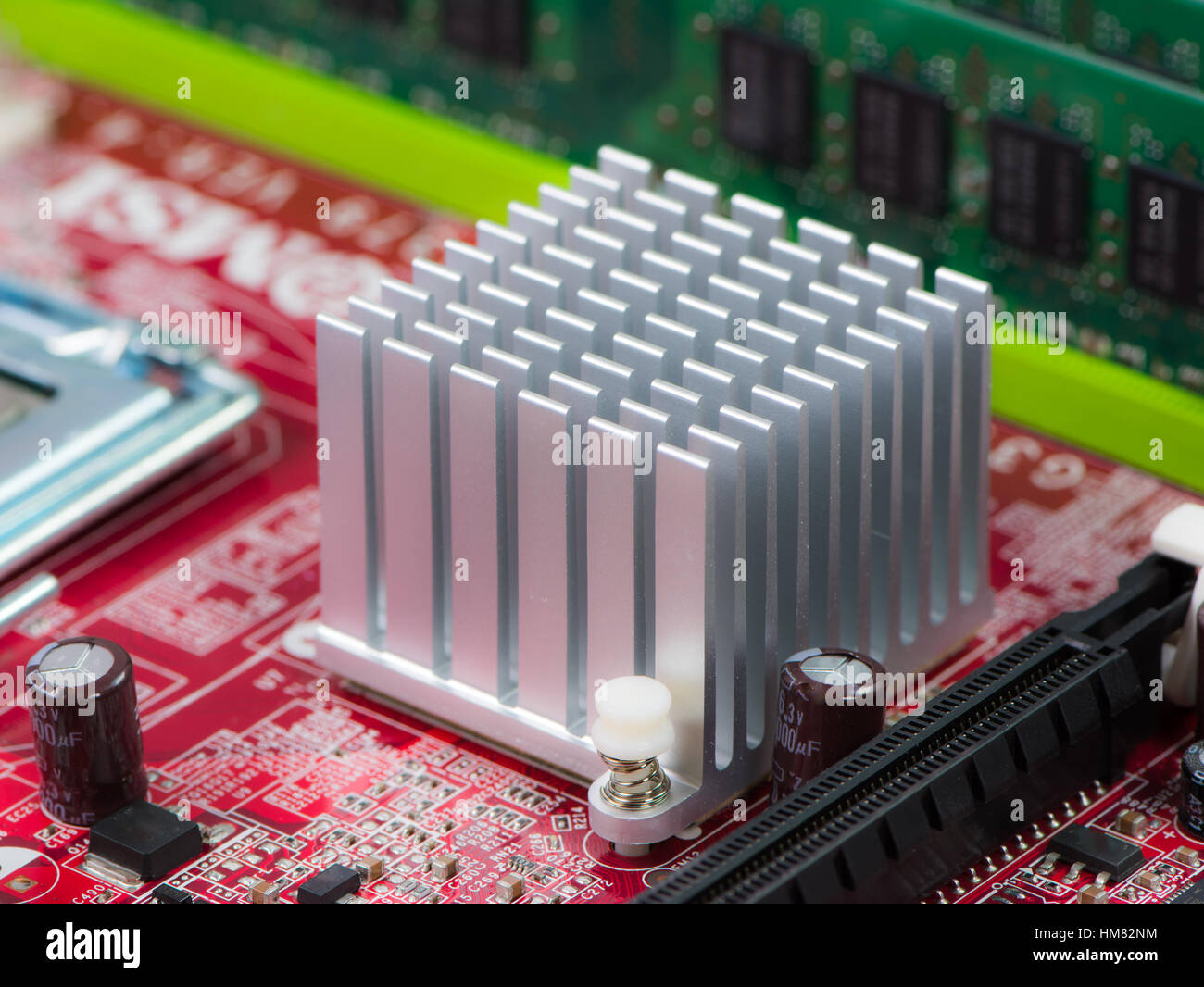 Silver heat sink on a computer motherboard Stock Photo