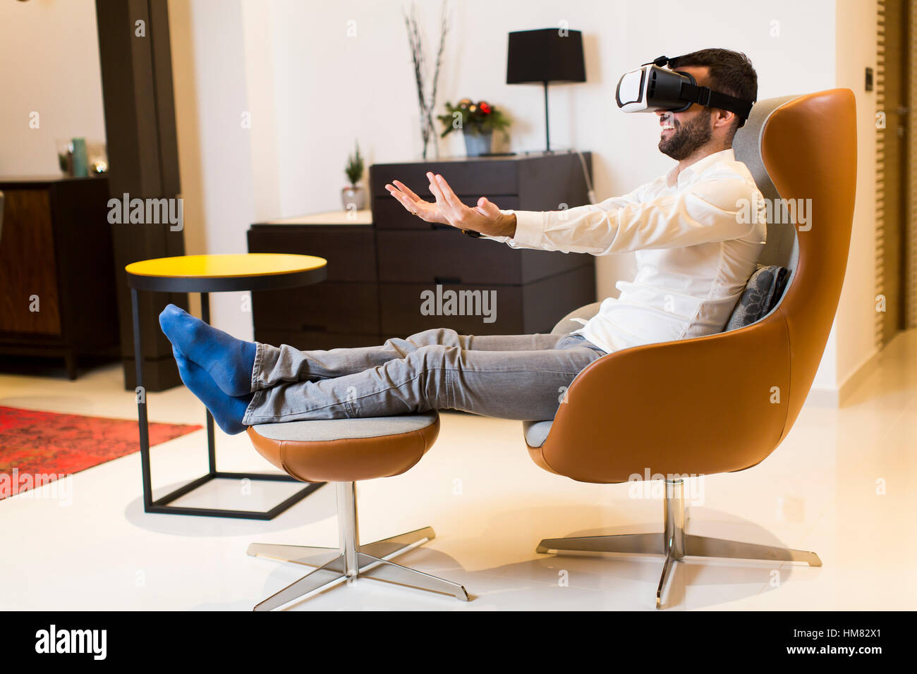 Young guy in virtual reality headset playing game Stock Photo - Alamy