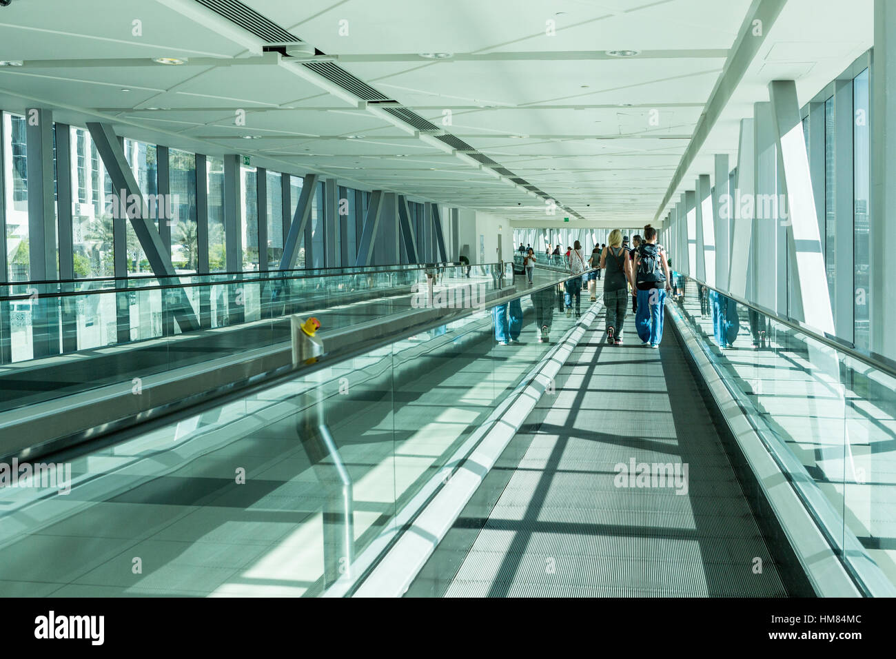 People On The Move On An Escalator Gangway To Dubai Mall From The