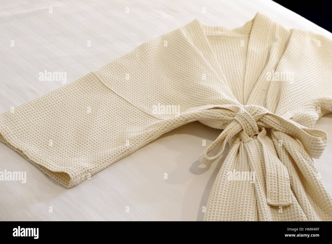 white bathrobe on the bed Stock Photo