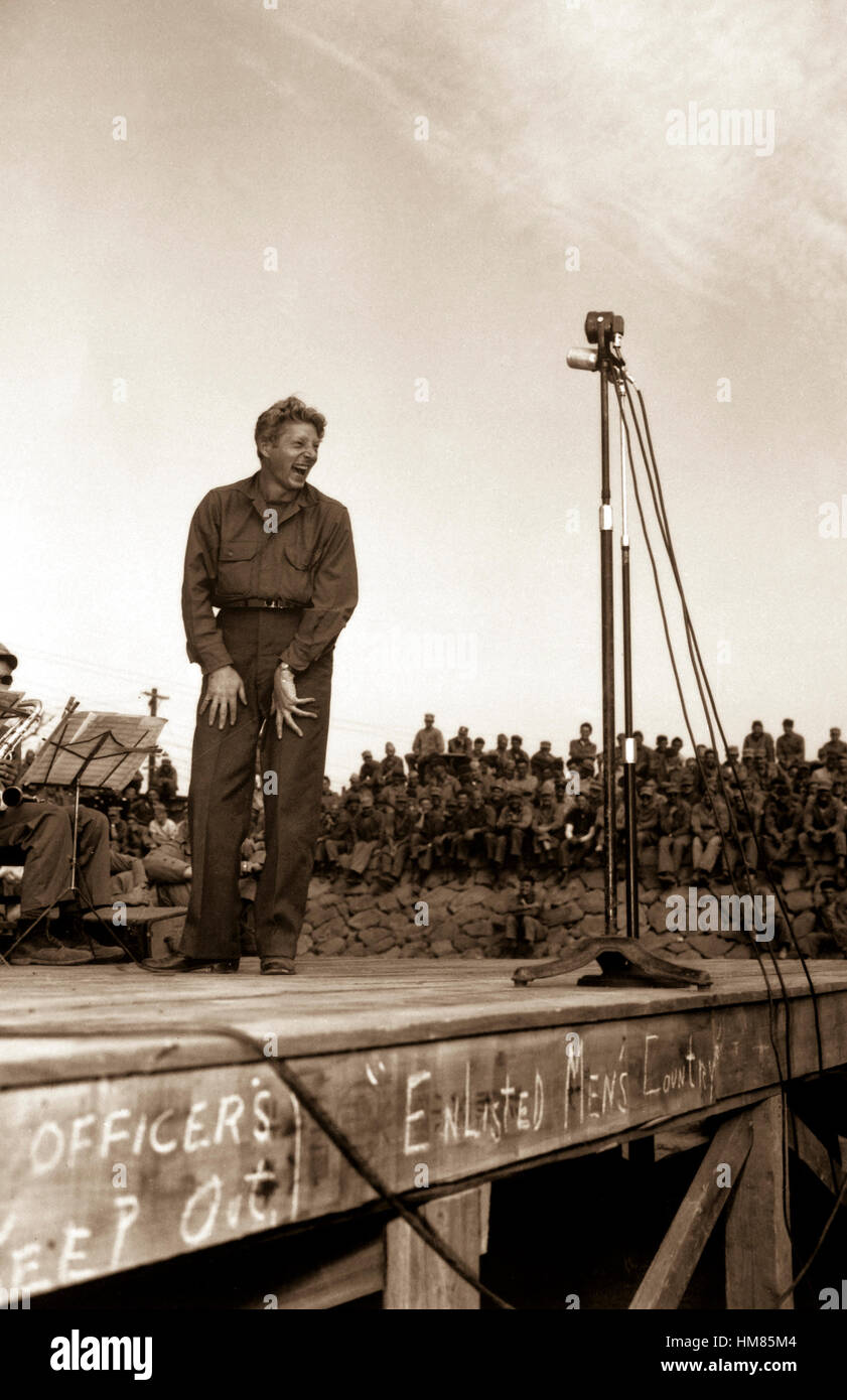 Danny Kaye, well  known stage and screen star, entertains 4,000 5th Marine Div. occupation troops at Sasebo, Japan.  The crude sign across the front of the stage says: 'Officers keep out!  Enlisted men's country.'  October 25, 1945. Pfc. H. J. Grimm. (Marine Corps) NARA FILE #:  127-N-138204 WAR & CONFLICT #:  903 Stock Photo