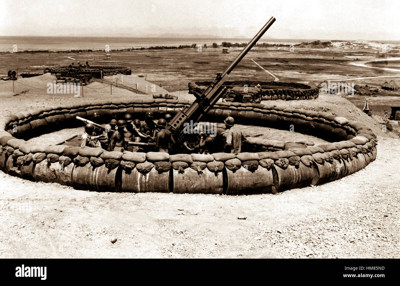 View of #4 90mm AAA gun emplacement with crew in pit.  'D' Battery, 98th AAA Gun Bn., 137th AAA Gp. Okinawa, July 18, 1945.  Hendrickson.  (Army) NARA FILE #:  111-SC-211476 WAR & CONFLICT BOOK #:  1225 Stock Photo