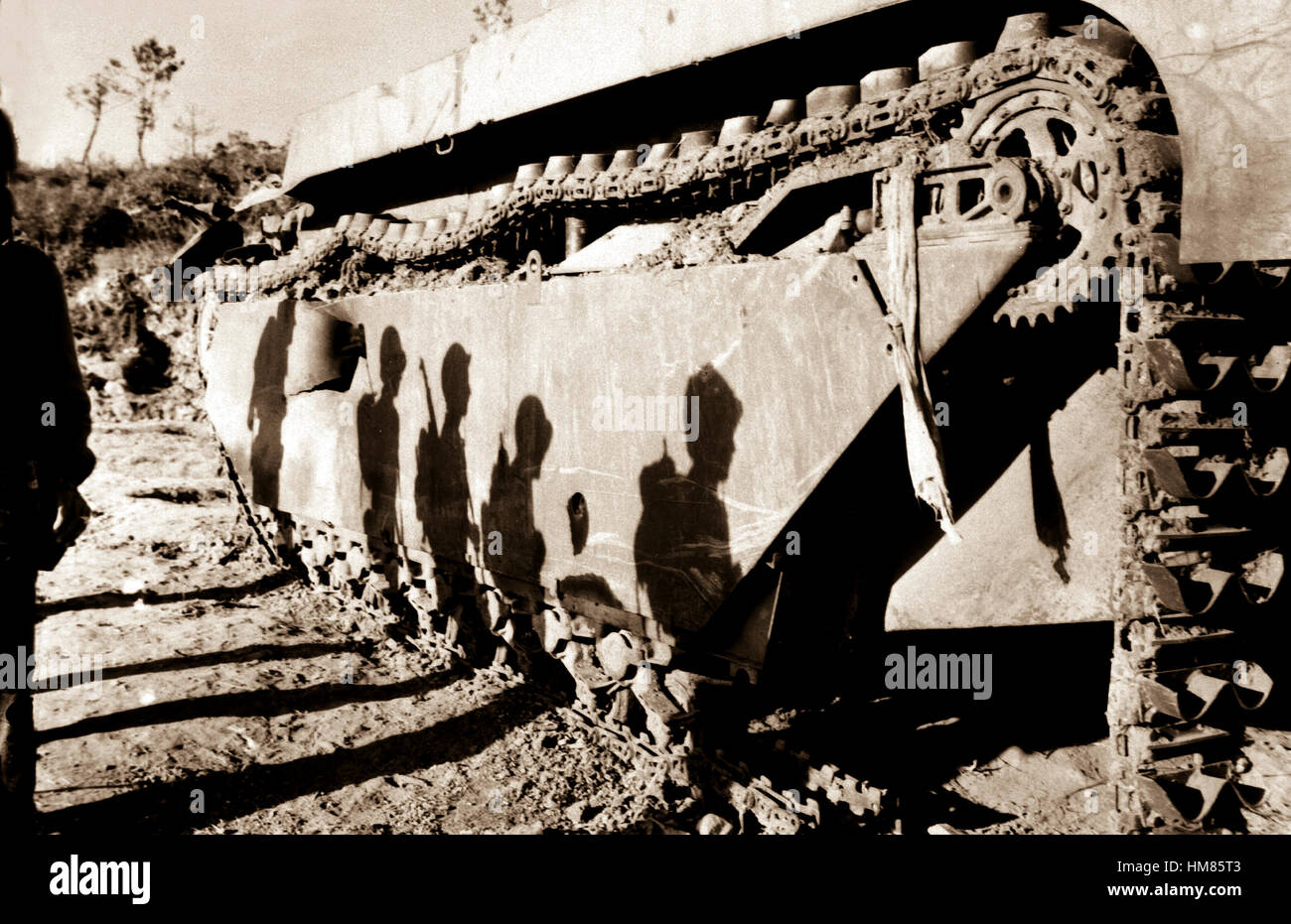 On the flank of a battle-wrecked alligator tank the Okinawa sun casts the shadows of 6th Division Marines as they move into to mop up the southern tip of the island.  1945.  Cpl. A. J. Giossi.   (Marine Corps) Exact Date Shot Unknown NARA FILE #:  127-N-95-127910 WAR & CONFLICT BOOK #:  1232 Stock Photo