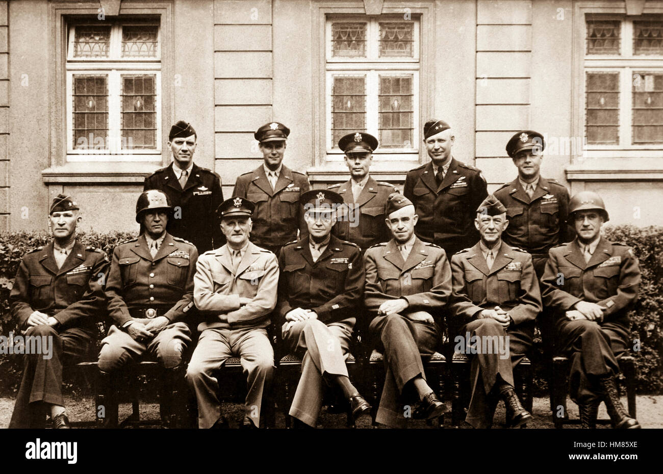 'This is the brass that did it.  Seated are Simpson, Patton (as if you didn't know), Spaatz, Ike himself, Bradley, Hodges and Gerow.  Standing are Stearley, Vandenberg, Smith, Weyland and Nugent.'  Ca. 1945. Army. (OWI) Exact Date Shot Unknown NARA FILE #:  208-YE-182 WAR & CONFLICT #:  751 Stock Photo