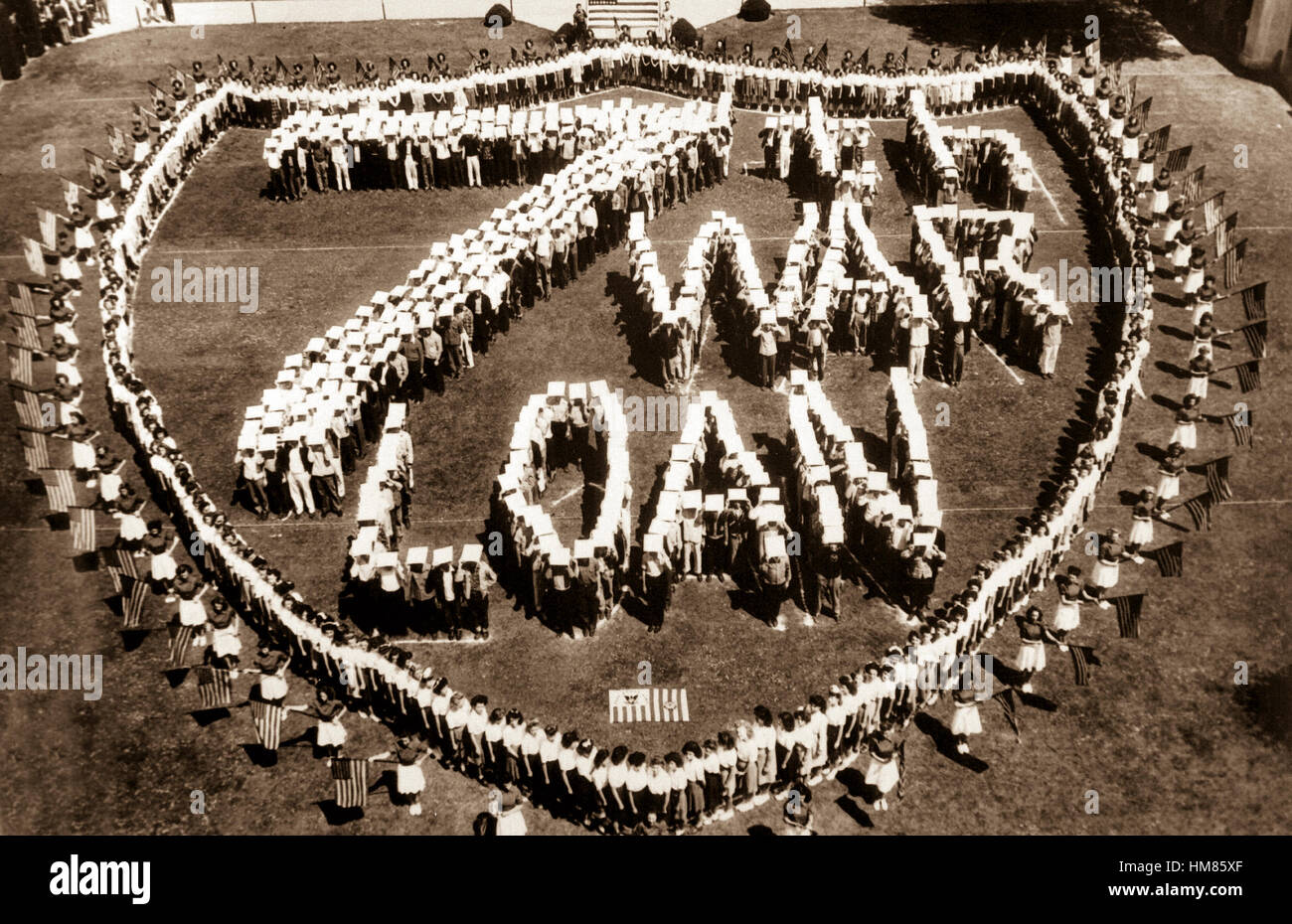 Forming a U.S. Coast Guard shield, high school students at Long Beach, Calif. make a striking appeal for the support of the current 7th War Loan drive, in which every purchase of a war bond helps to land that knockout blow against the Japs.  Ca. 1945. (Coast Guard) Exact Date Shot unknown NARA FILE #:  026-G-4548 WAR & CONFLICT #:  770 Stock Photo