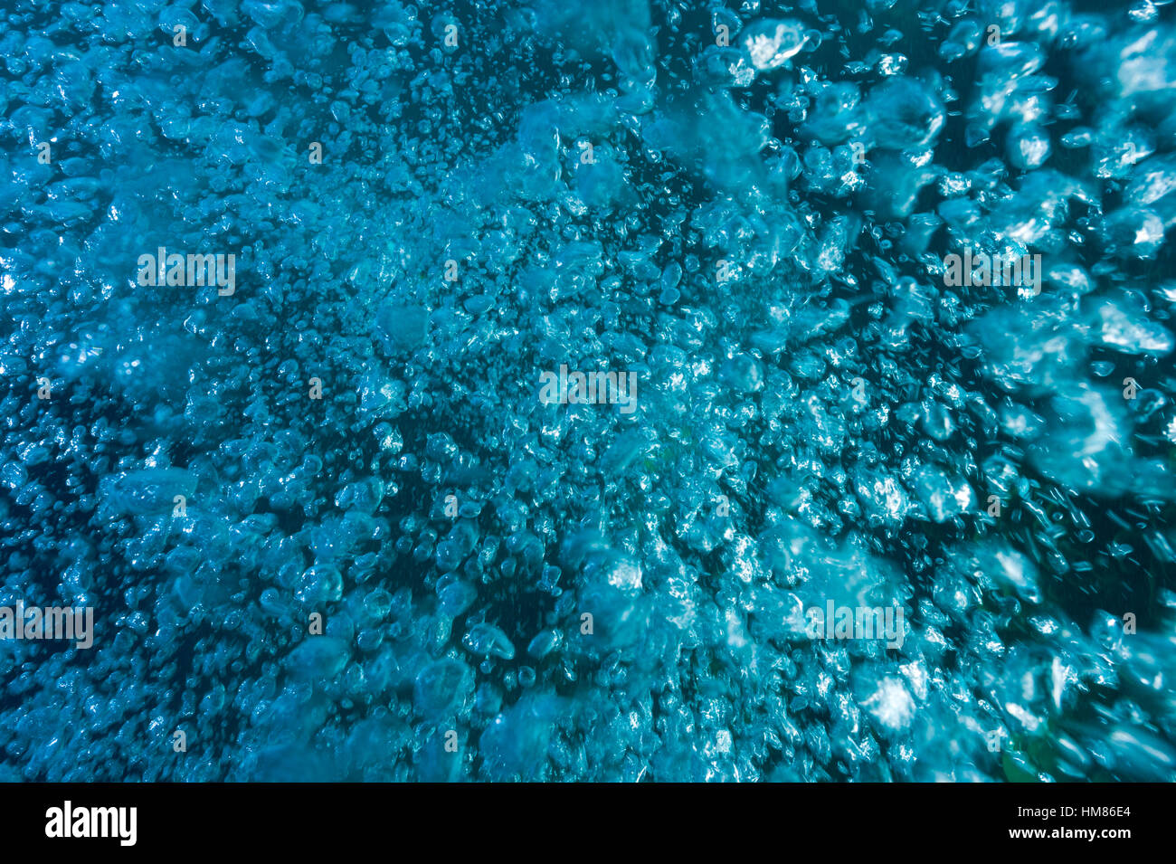 A cluster of air bubbles from a scuba divers tank floating to the surface from the depths. Stock Photo