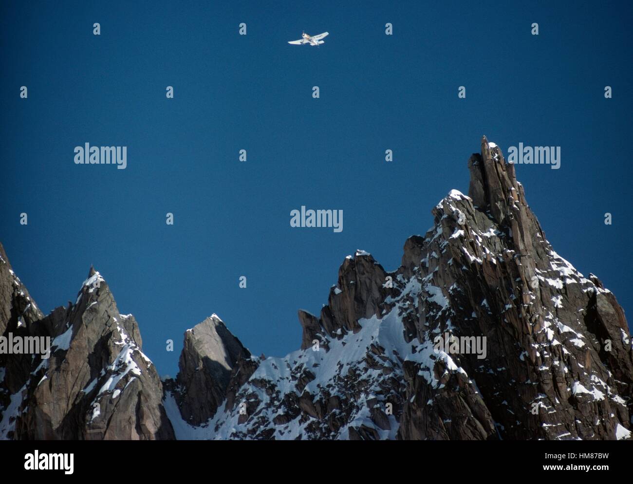 An airplane flying over the Dent du Requin (3422 m), Mont Blanc massif, Upper Savoy, Auvergne-Rhone-Alpes, France. Stock Photo