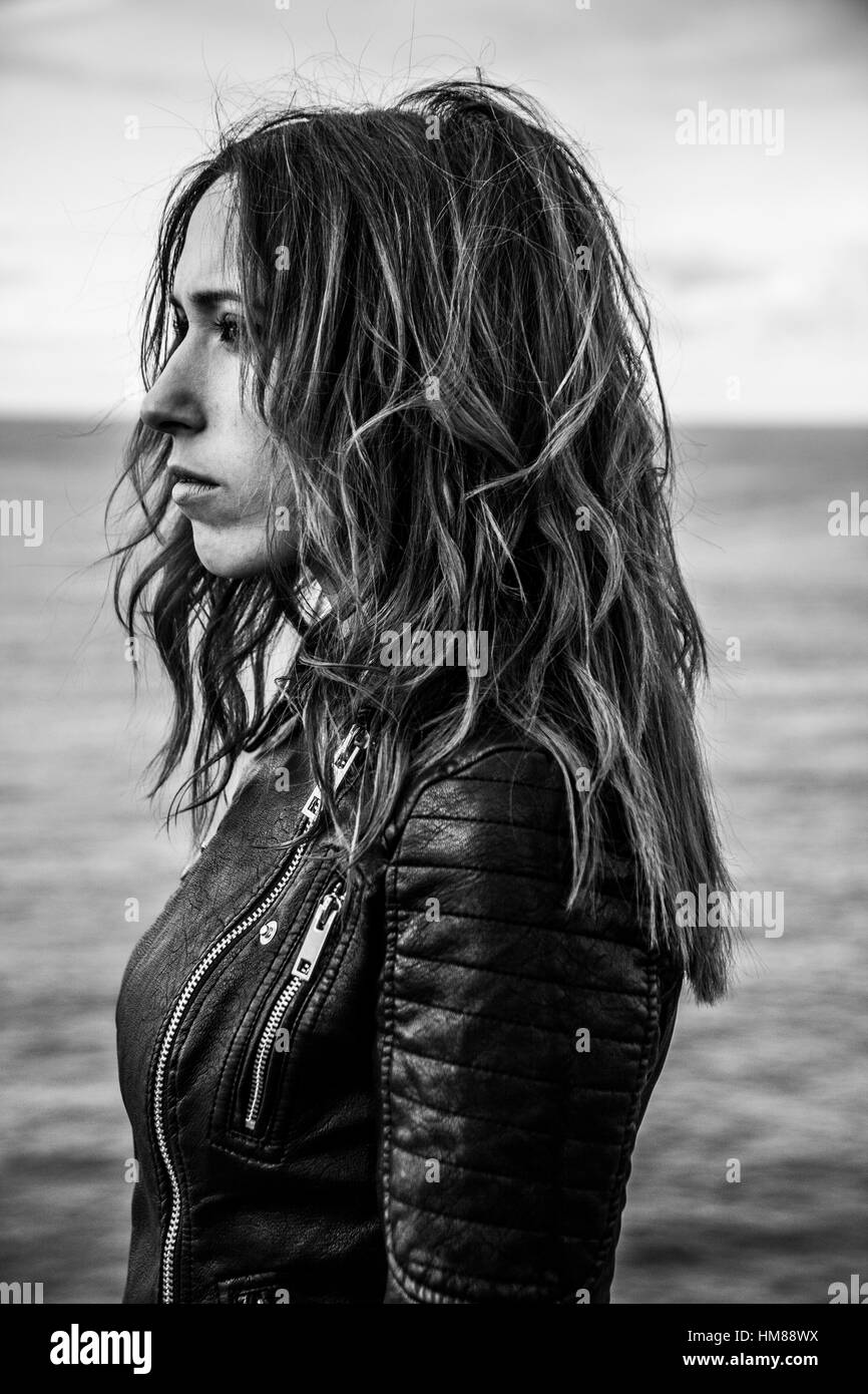 Profile Portrait of Young Adult Woman in Leather Jacket Stock Photo
