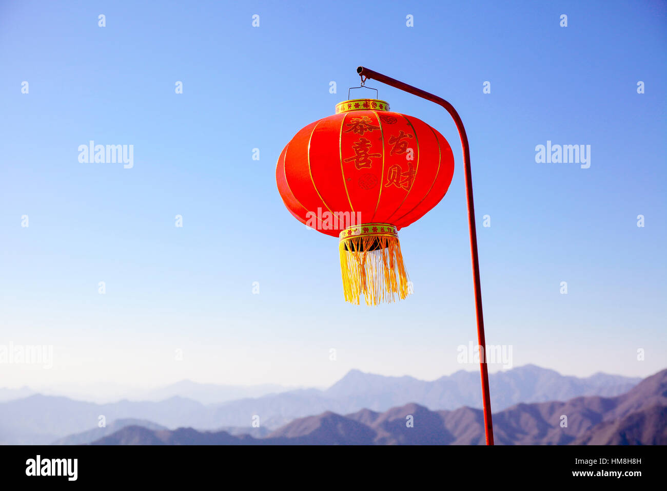 Chinese new year lantern hanging on the pole over blue sky and ...