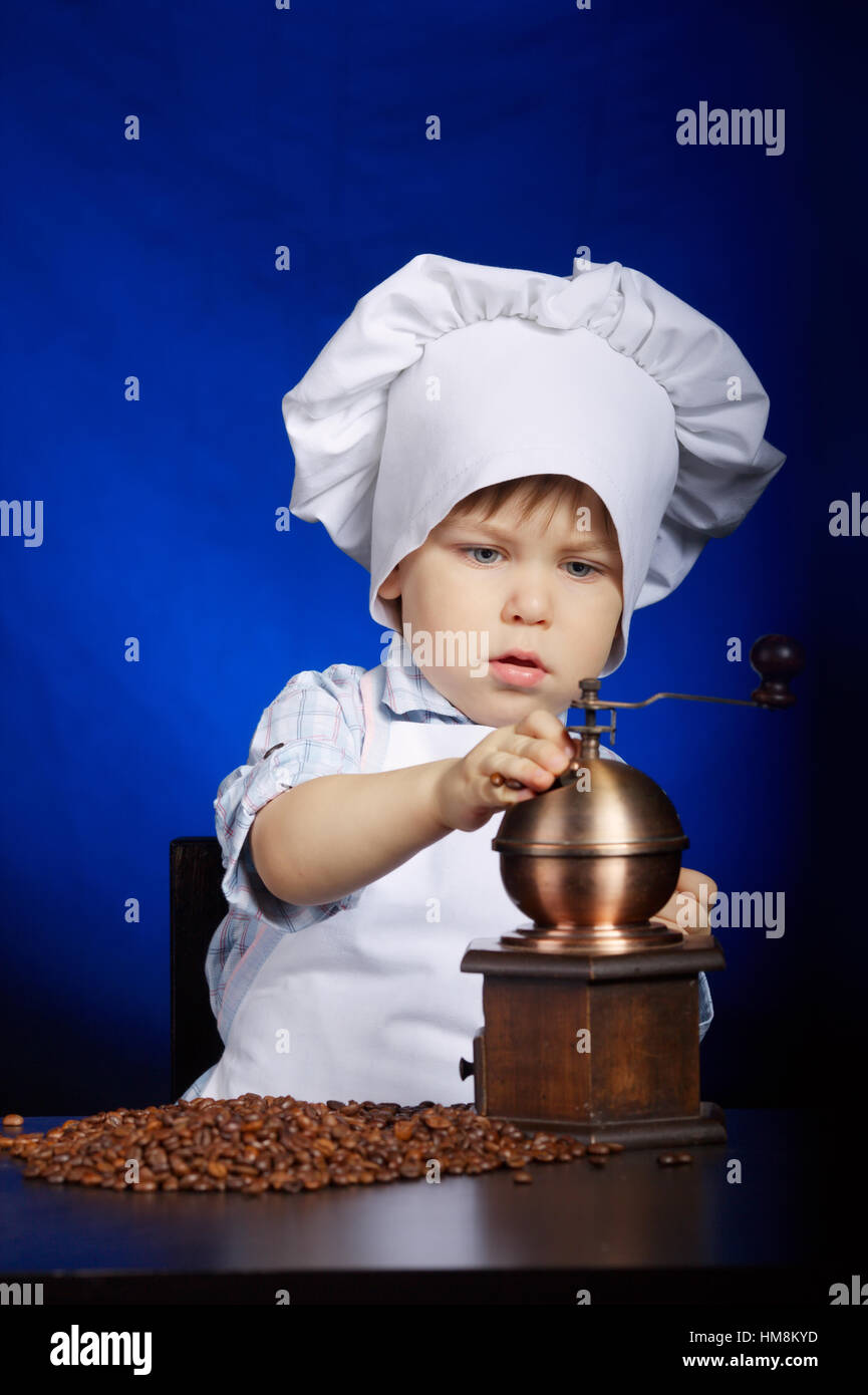 little boy plays with coffee mill Stock Photo Alamy