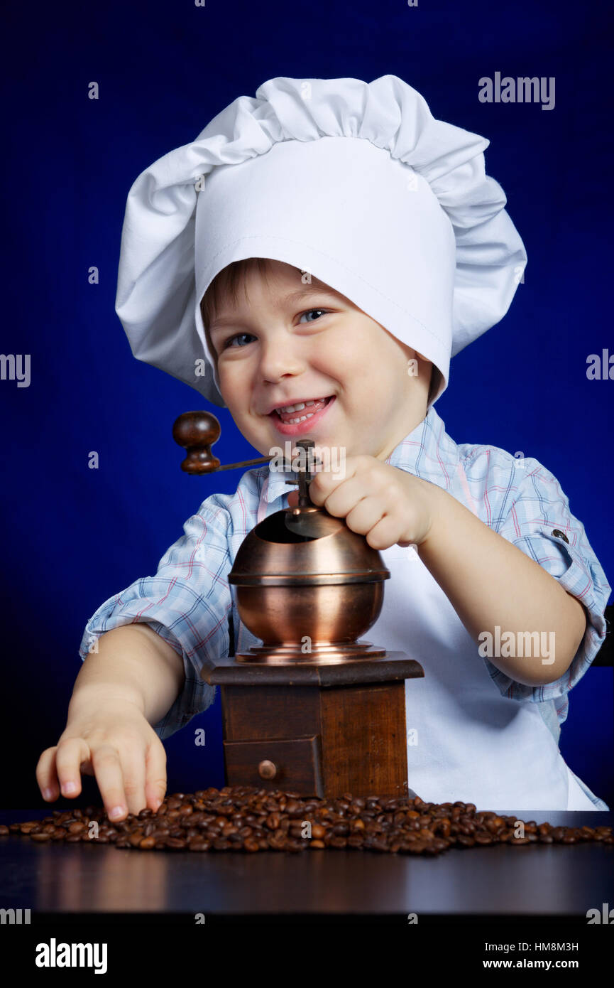 little boy plays with coffee mill Stock Photo Alamy