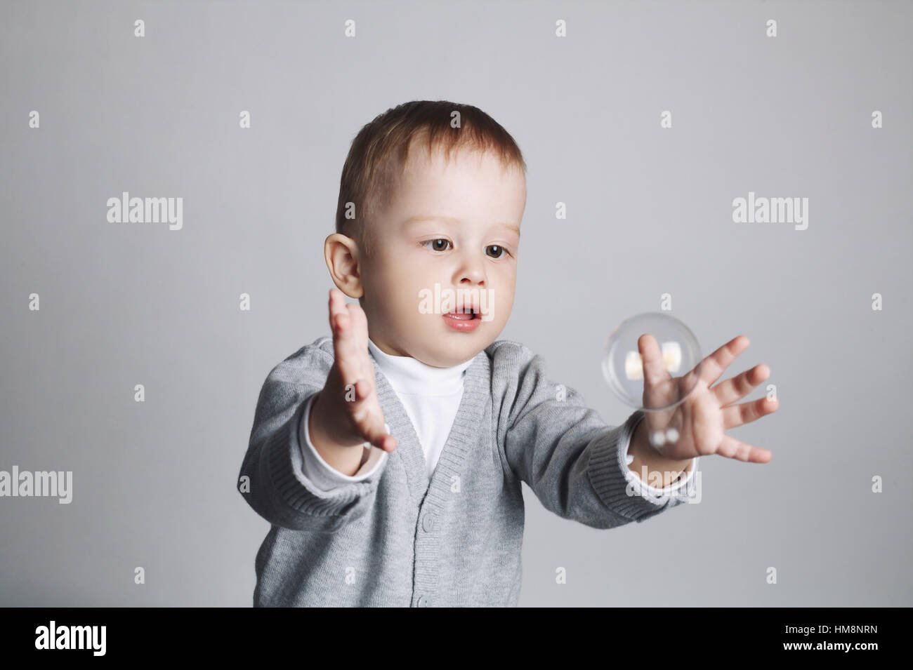 little funny boy plays with bubbles Stock Photo Alamy