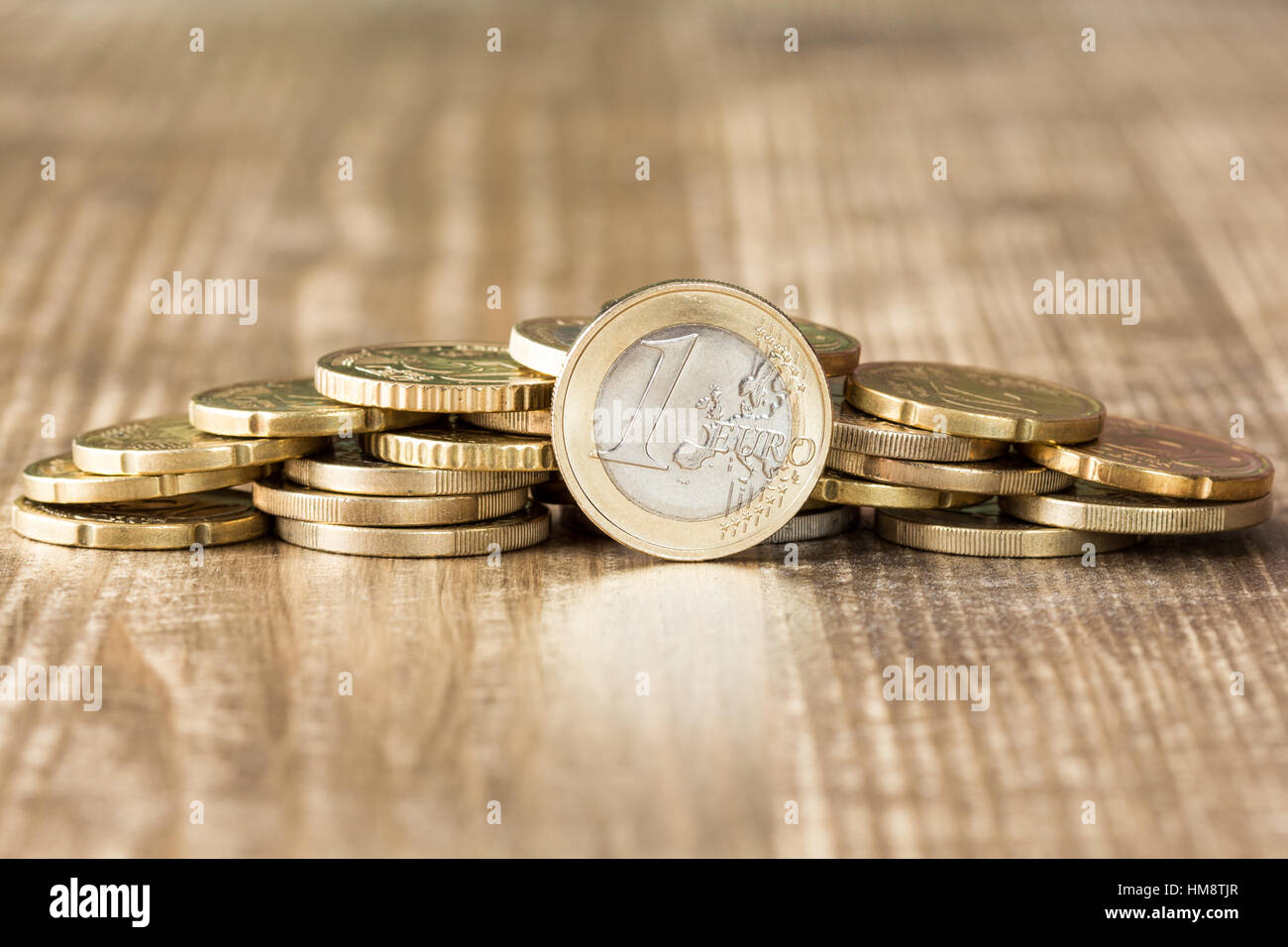 Euro coins on the wooden table surface Stock Photo