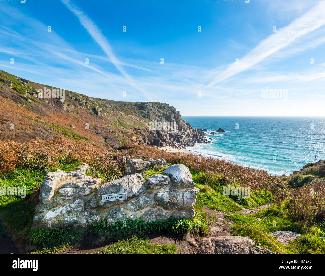 St Levans Well, near Porthcurno, Cornwall. The headland is known as Pedn-men-an-mere and the offshore rocks are the Carracks. Stock Photo