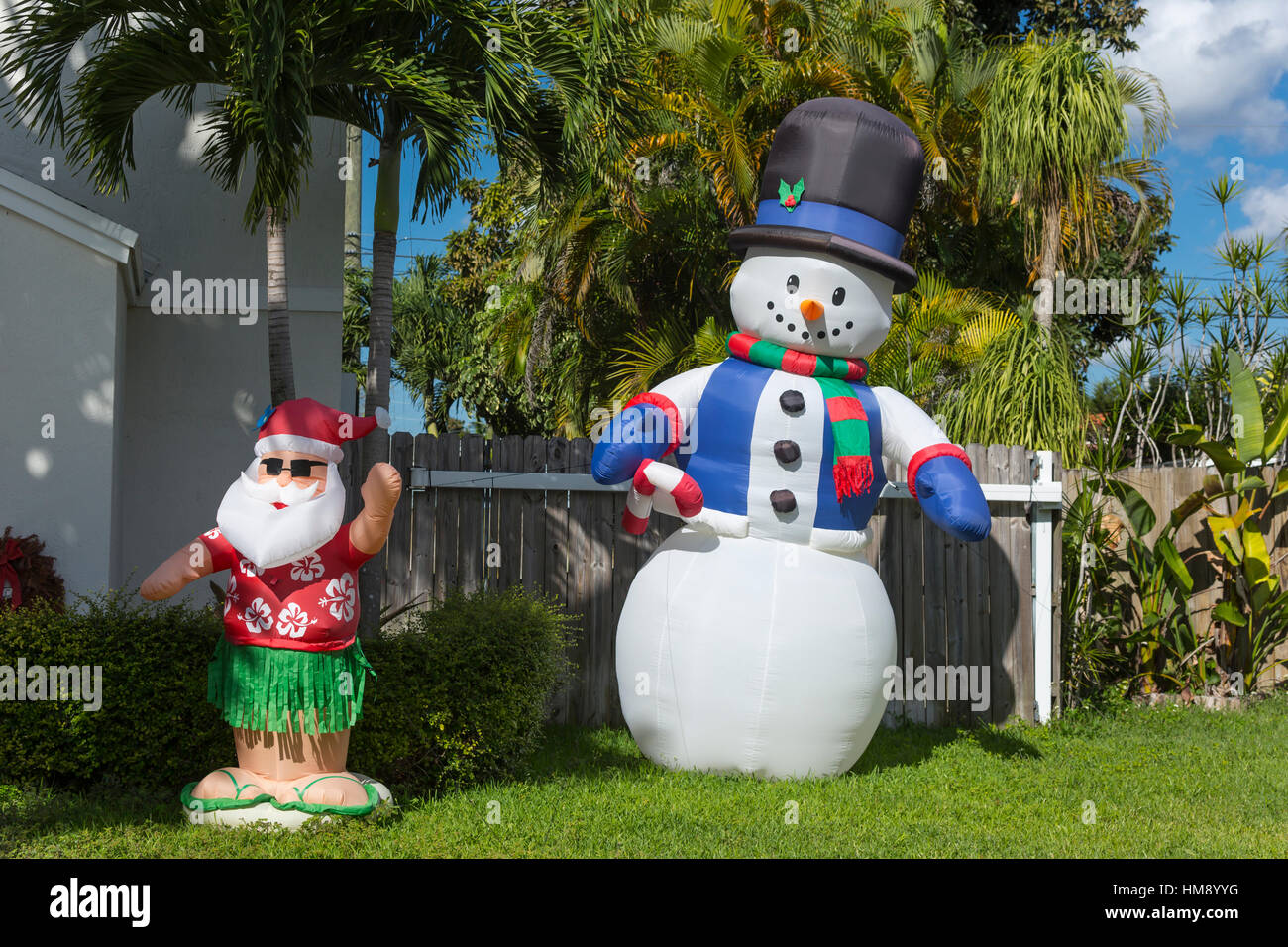 INFLATABLE SANTA CLAUS AND SNOWMAN IN FRONT OF PALM TREES IN