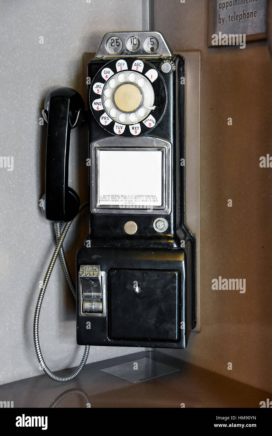 retro black pay telephone in phone booth Stock Photo
