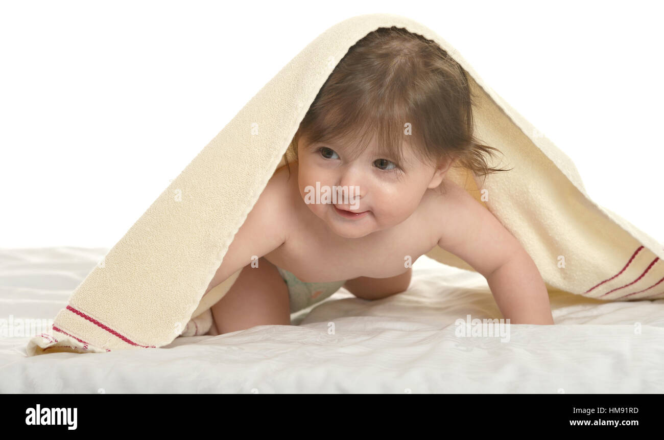 Baby girl lying under blanket Stock Photo Alamy
