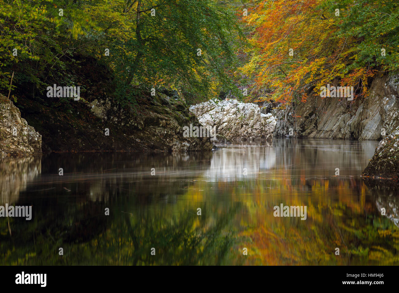 Autumn colour reflected in the River Garry, Perthshire, Scottish Highlands, Scotland, United Kingdom Stock Photo