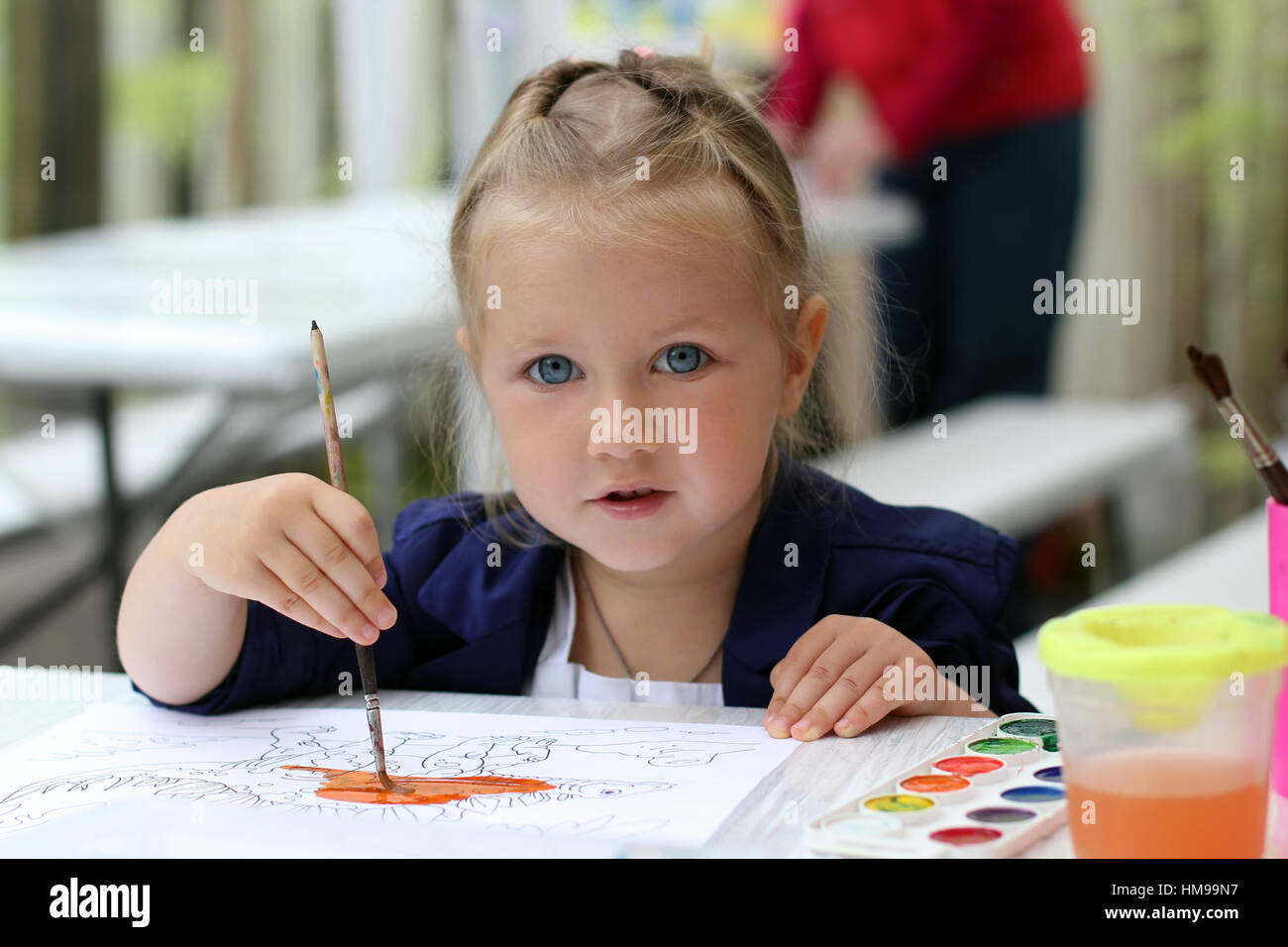 Cute little girl painting watercolors Stock Photo - Alamy