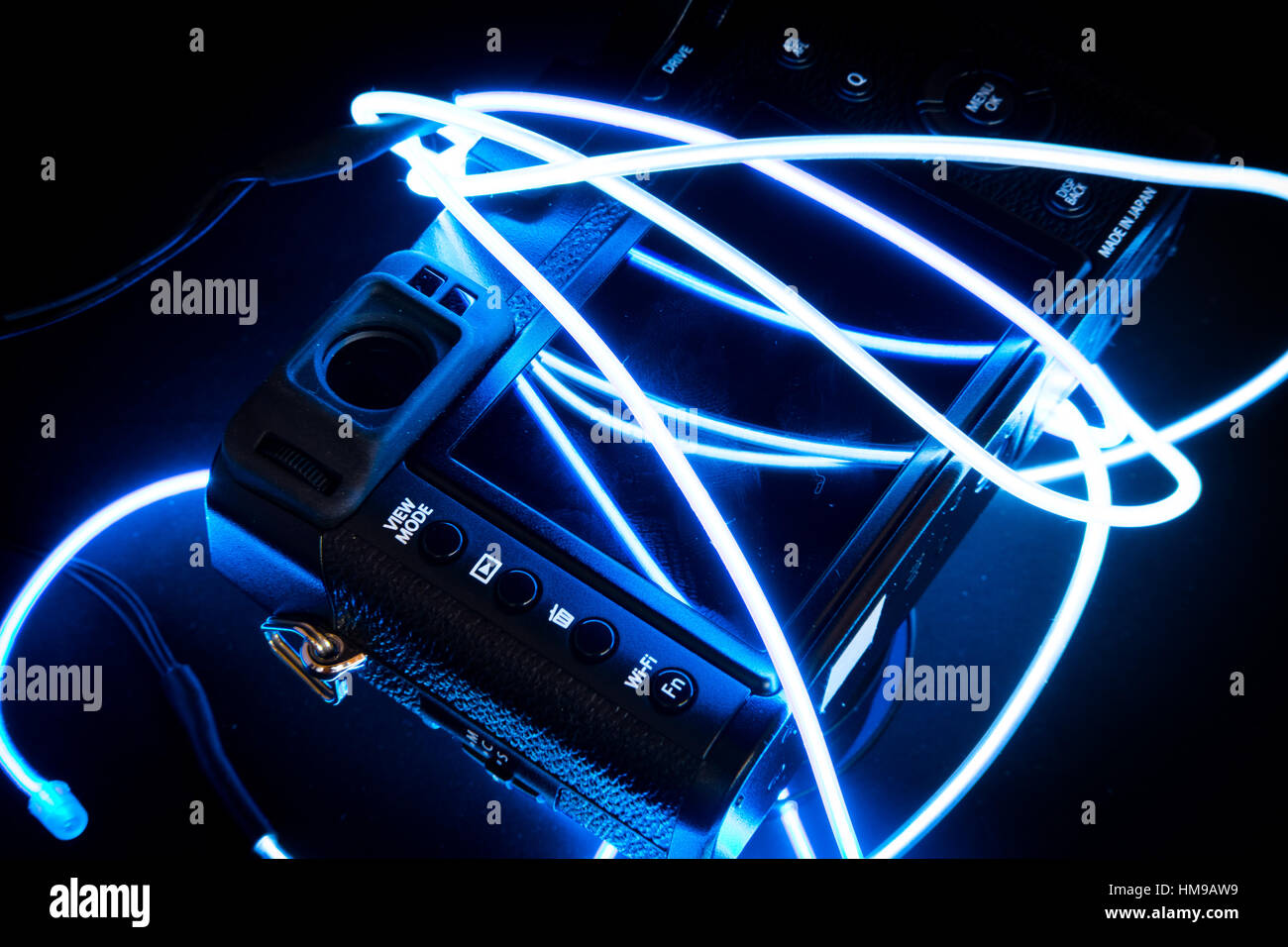 High-end digital camera lit by neon lights Stock Photo