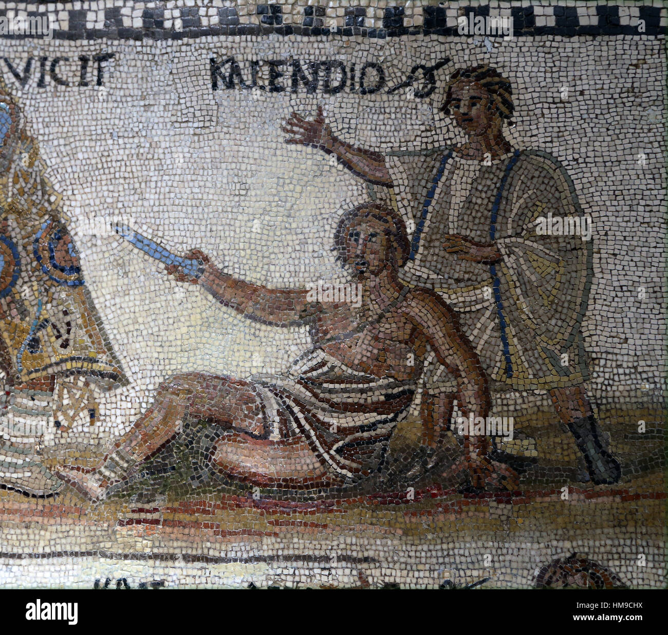 Secutor versus retiarius. Mosaic. Limestone. 3rd century. Rome. Upper frame. Retiarius Kalendio lives wounded on the ground . Stock Photo