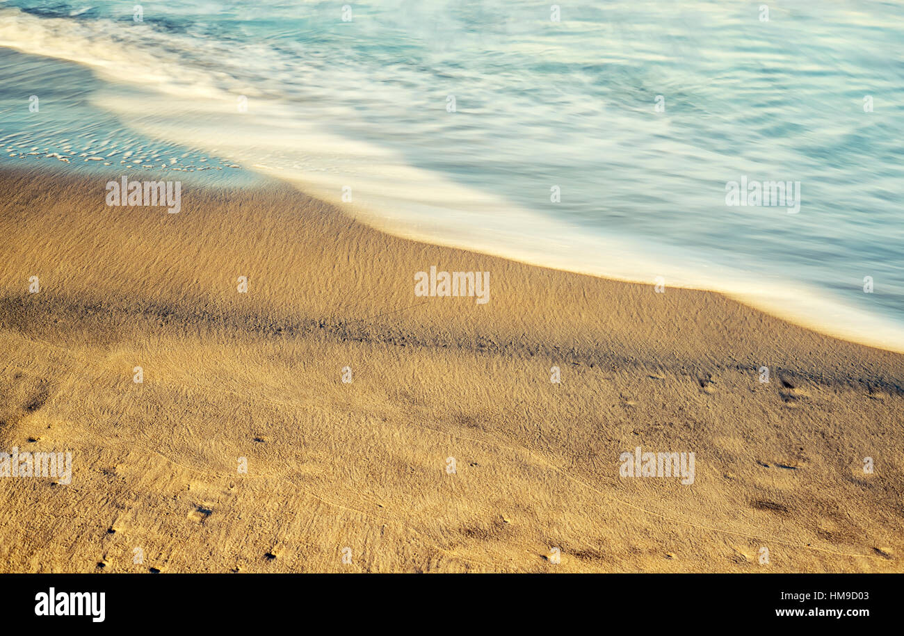 beach, sand, and wave motion. long exposure image. Stock Photo