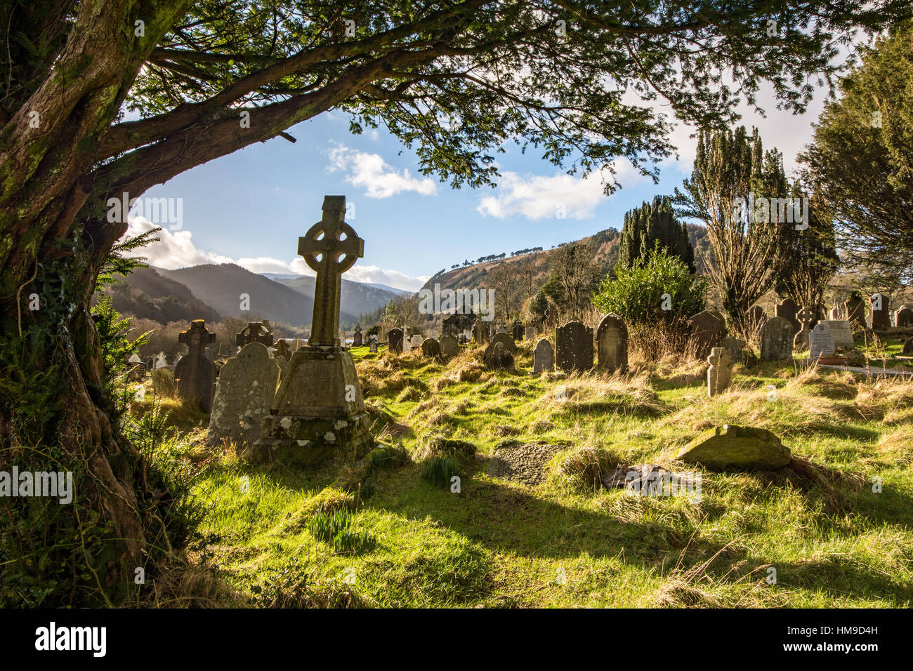 Celtic Cross in the old Cemetery at Glendalough in the Wicklow Mountains National Park in Ireland Stock Photo
