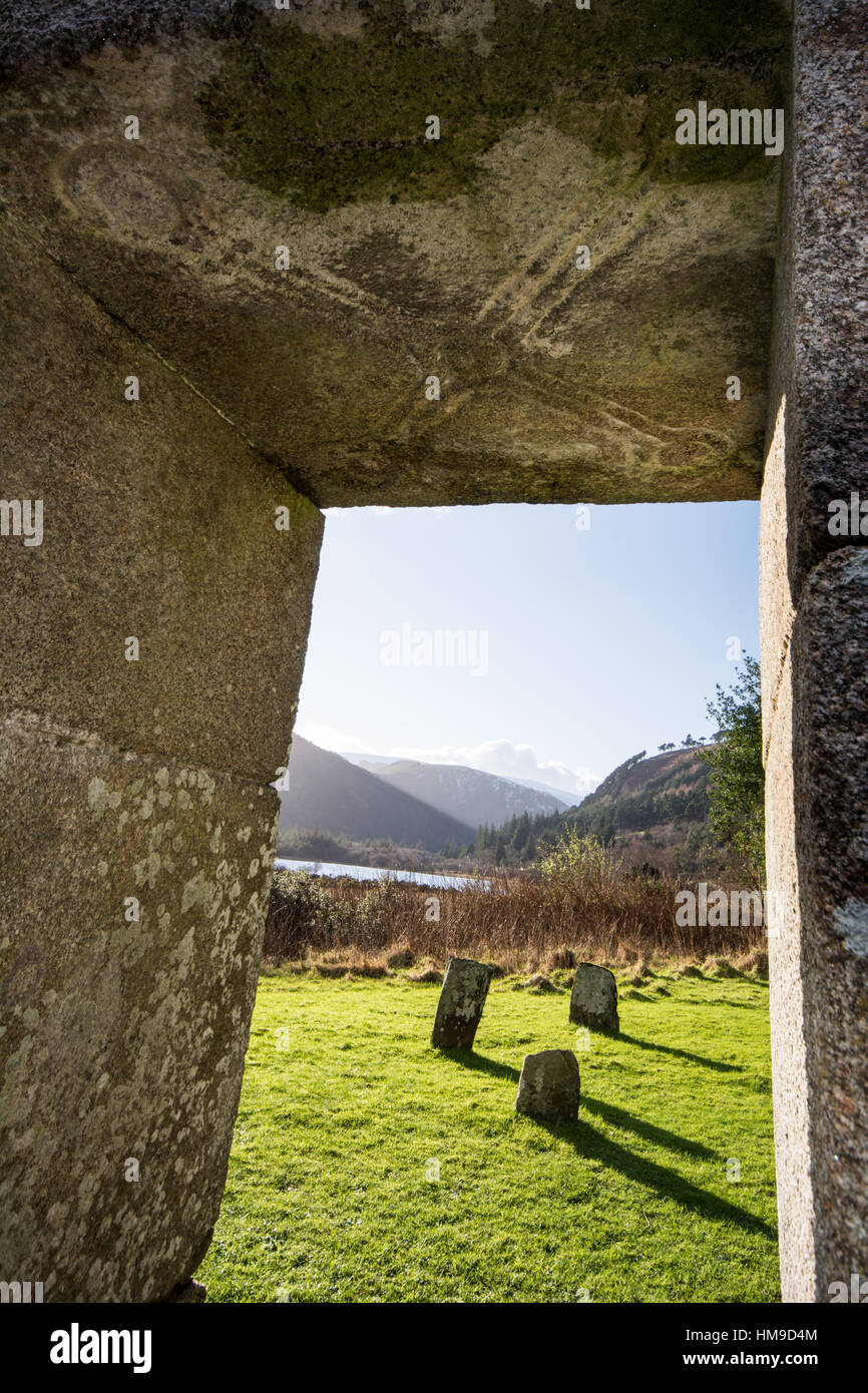 View of Glendalough valley from Our Lady's Church at Glendalough, Wicklow, Ireland with a view of saltire cross carved into granite lintel of doorway. Stock Photo