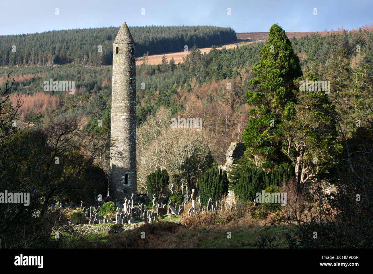 Round Tower and Cemeteryat Glendalough in the Wicklow Mountains in Ireland Stock Photo