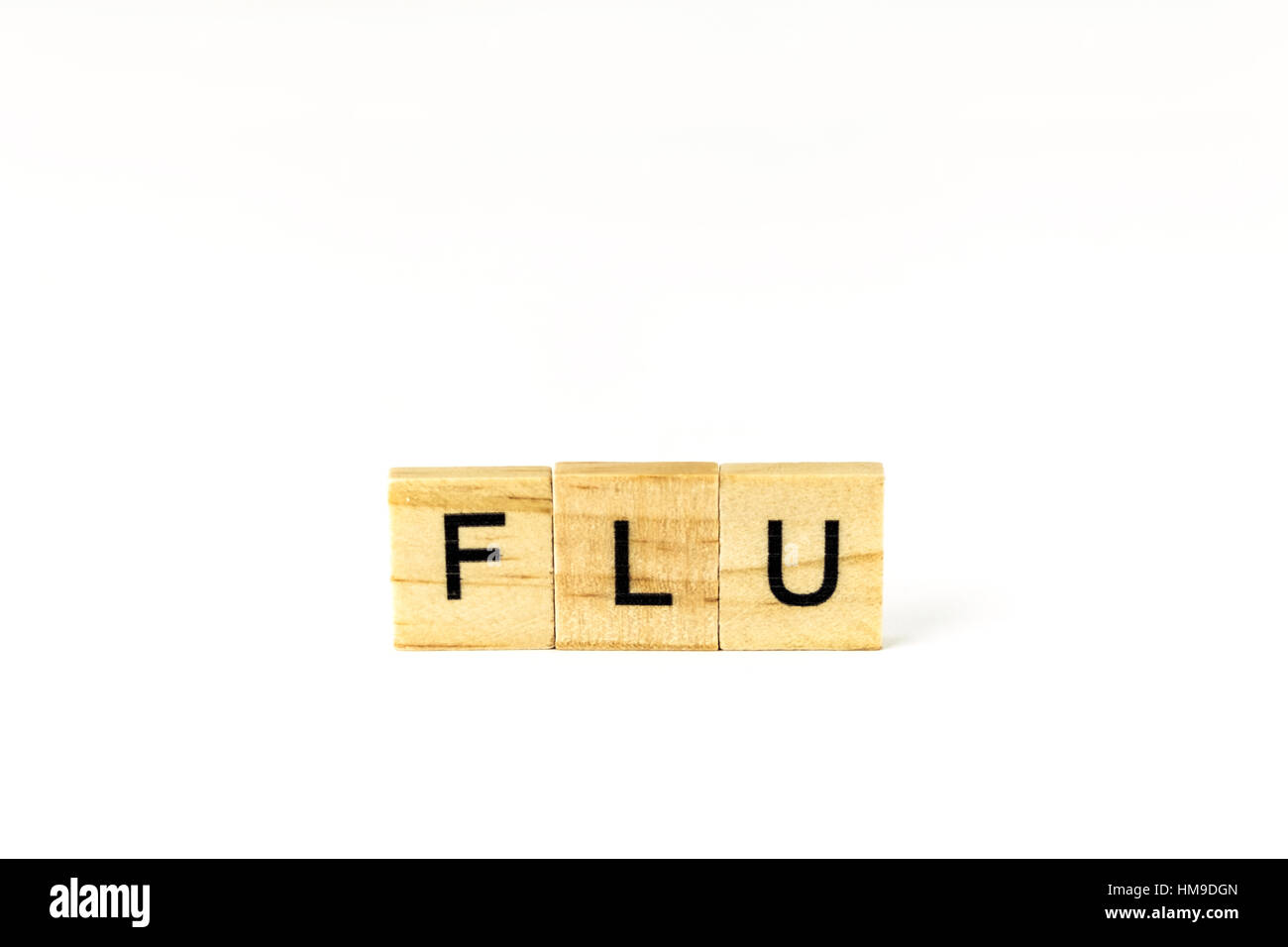 Block letters spelling 'Flu', a desease and health issue. Cutout. Stock Photo