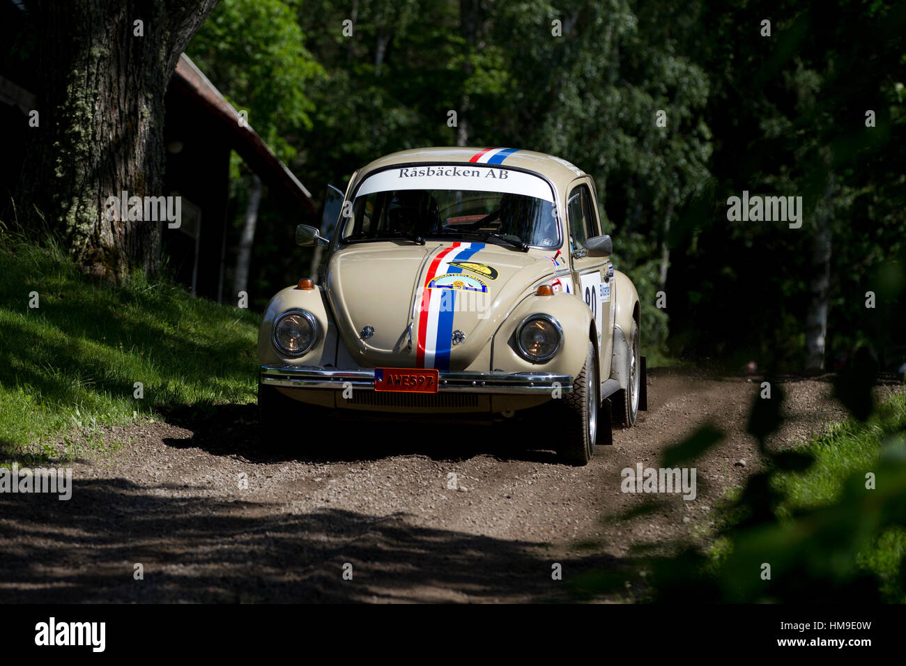 Rally car at full speed on a dirt road in Sweden Stock Photo