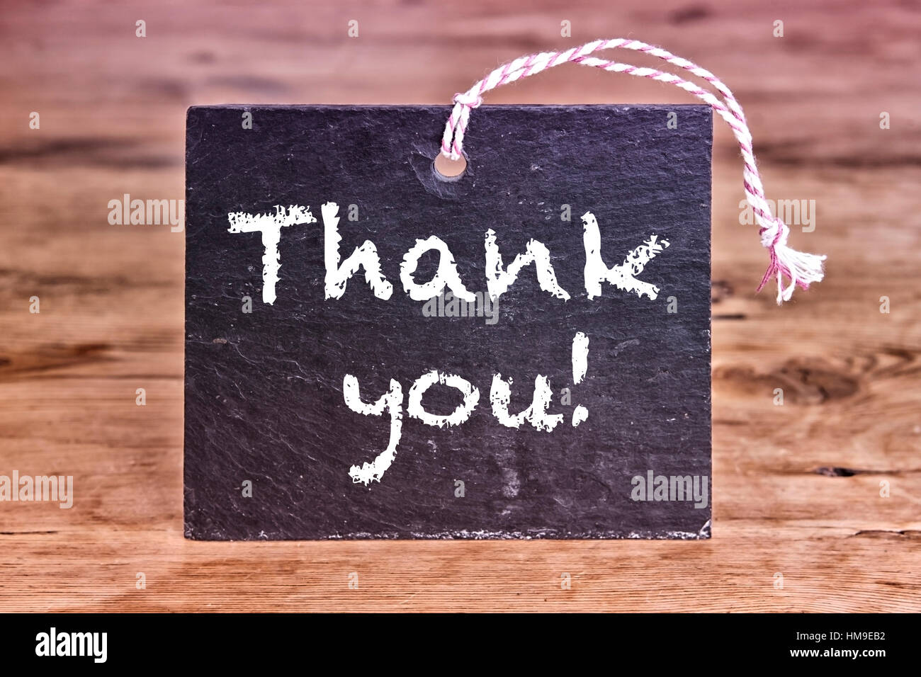 Thank You written on chalkboard on wooden table Stock Photo - Alamy
