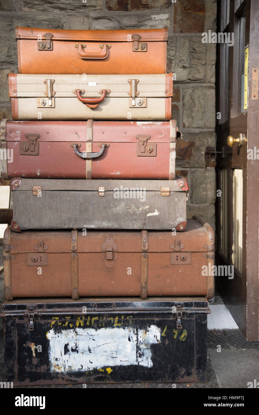 Vintage suitcases and luggage stacked at Bodmin & Wenford Railway in Cornwall Stock Photo