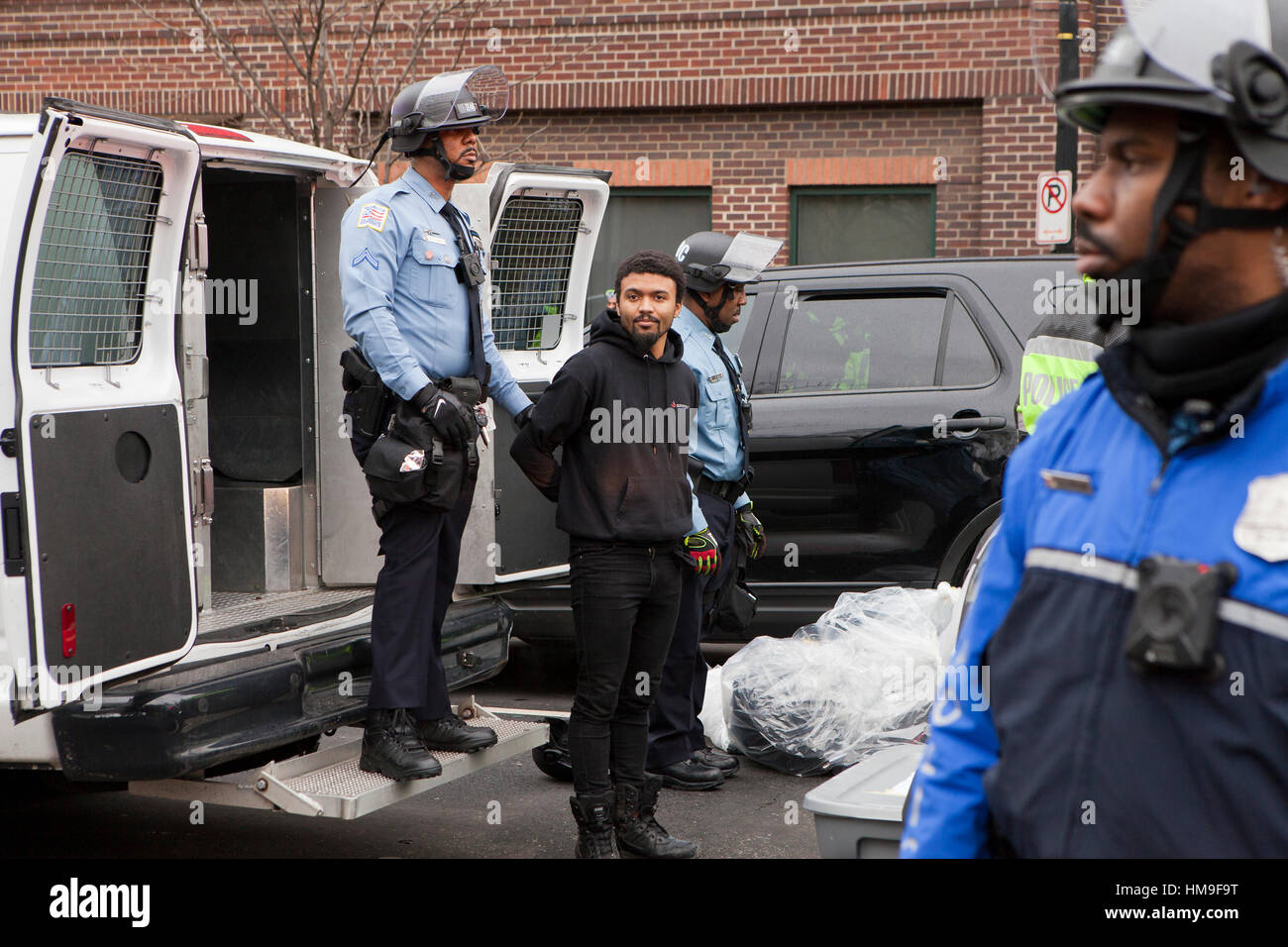 Young African-American man being arrested during 2017 presidential inauguration protest - Washington, DC USA Stock Photo