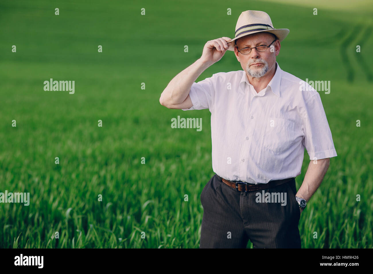Old man in field stock photo alamy