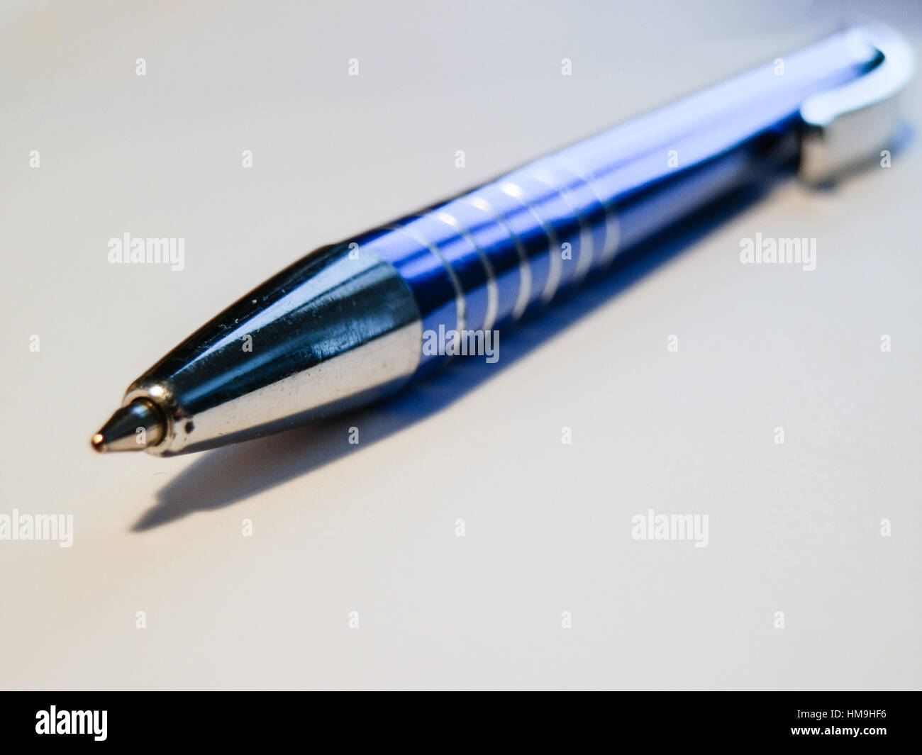 Sharp blue steel pen macro on white backround. 2 Stock Photo - Alamy