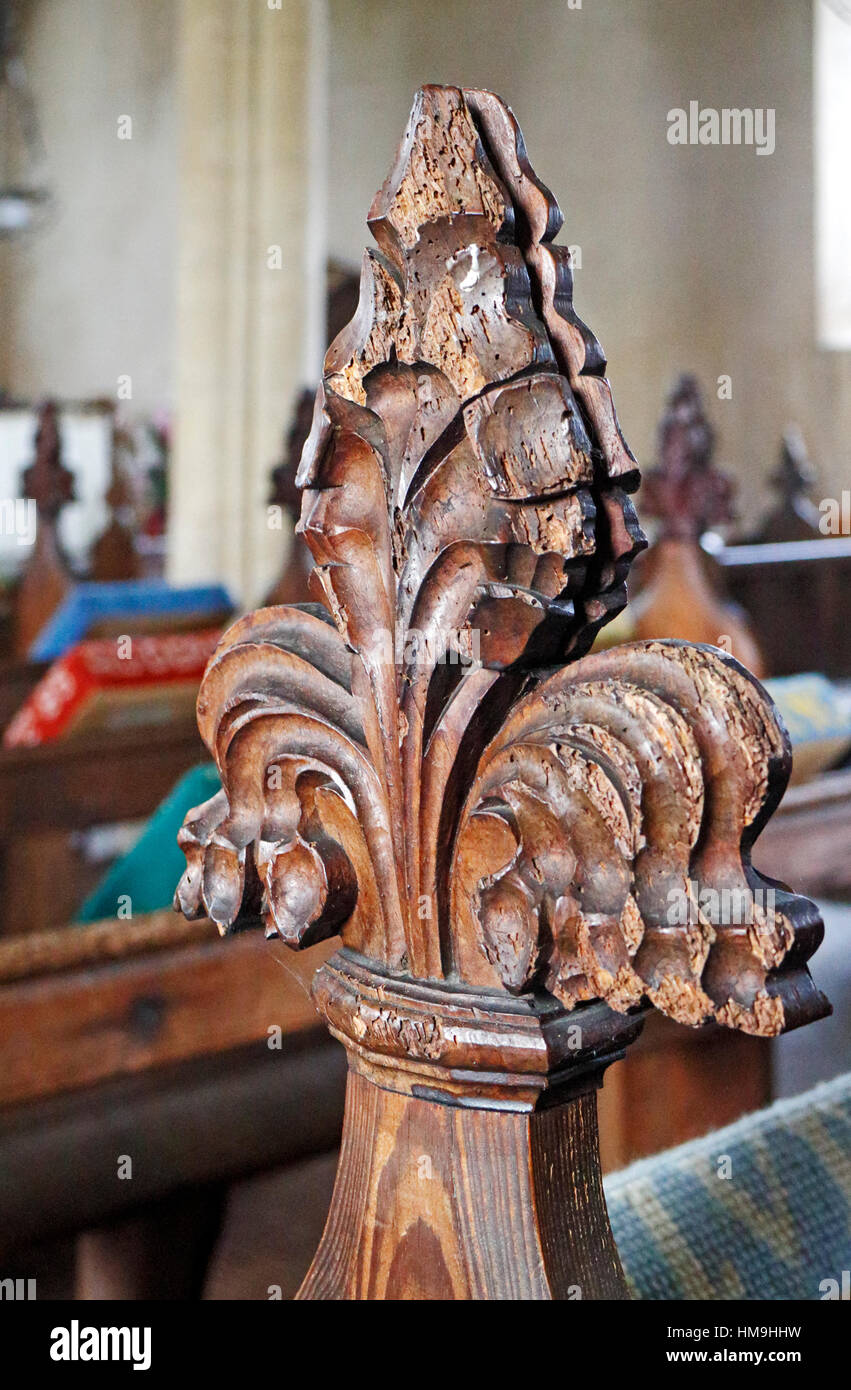 A poppy head bench end in the parish church of St Peter at Billingford, Norfolk, England, United Kingdom. Stock Photo