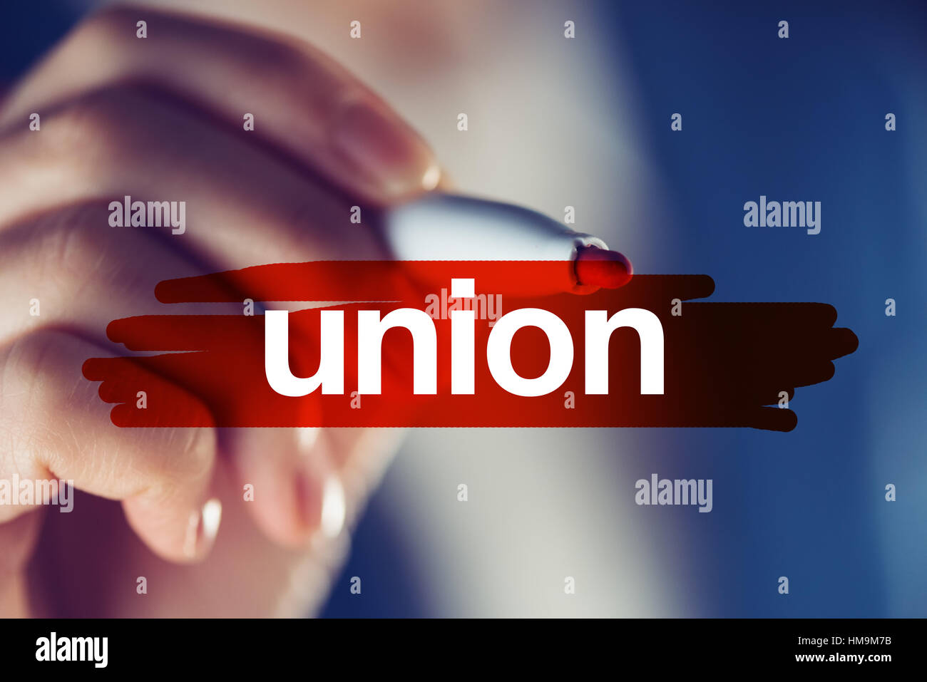 Business union concept, businesswoman highlighting word with red marker pen Stock Photo