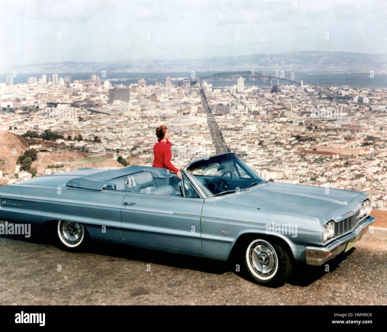 CHEVROLET IMPALA SS convertible coupe the 1964  third generation model with  San Francisco's Golden Gate Bridge in the distance. Photo: General Motors Stock Photo