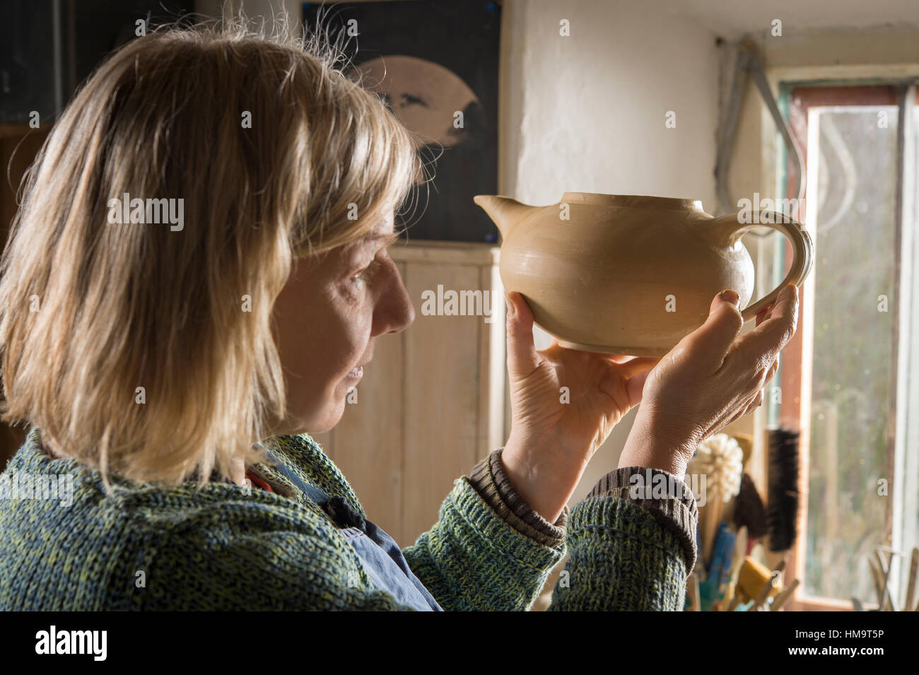 Ceramic workshop, woman checks handle on pot, Pittenhart, Upper Bavaria, Germany Stock Photo