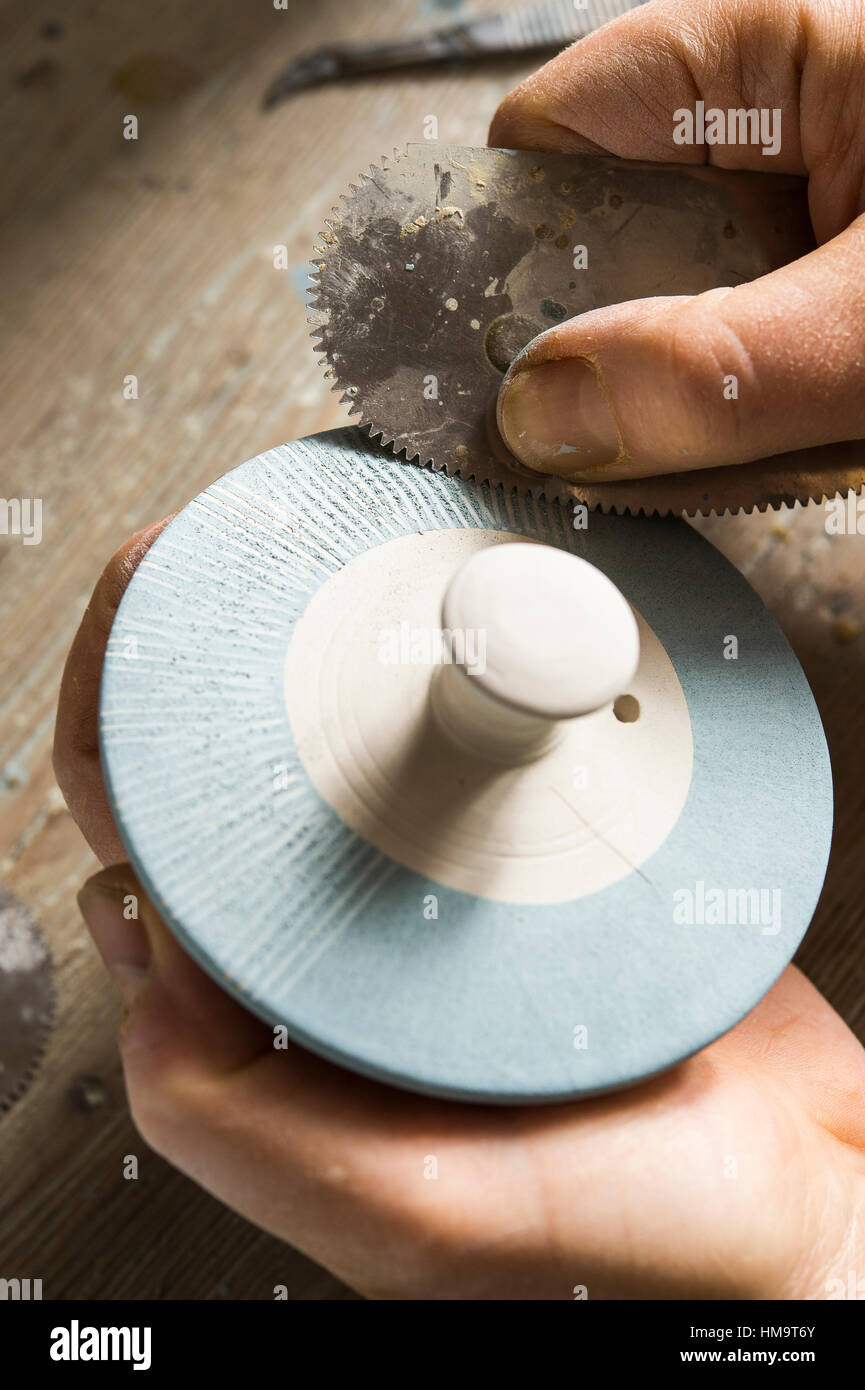 Ceramic workshop, finished lid is scratched with metal comb, Pittenhart, Upper Bavaria, Germany Stock Photo
