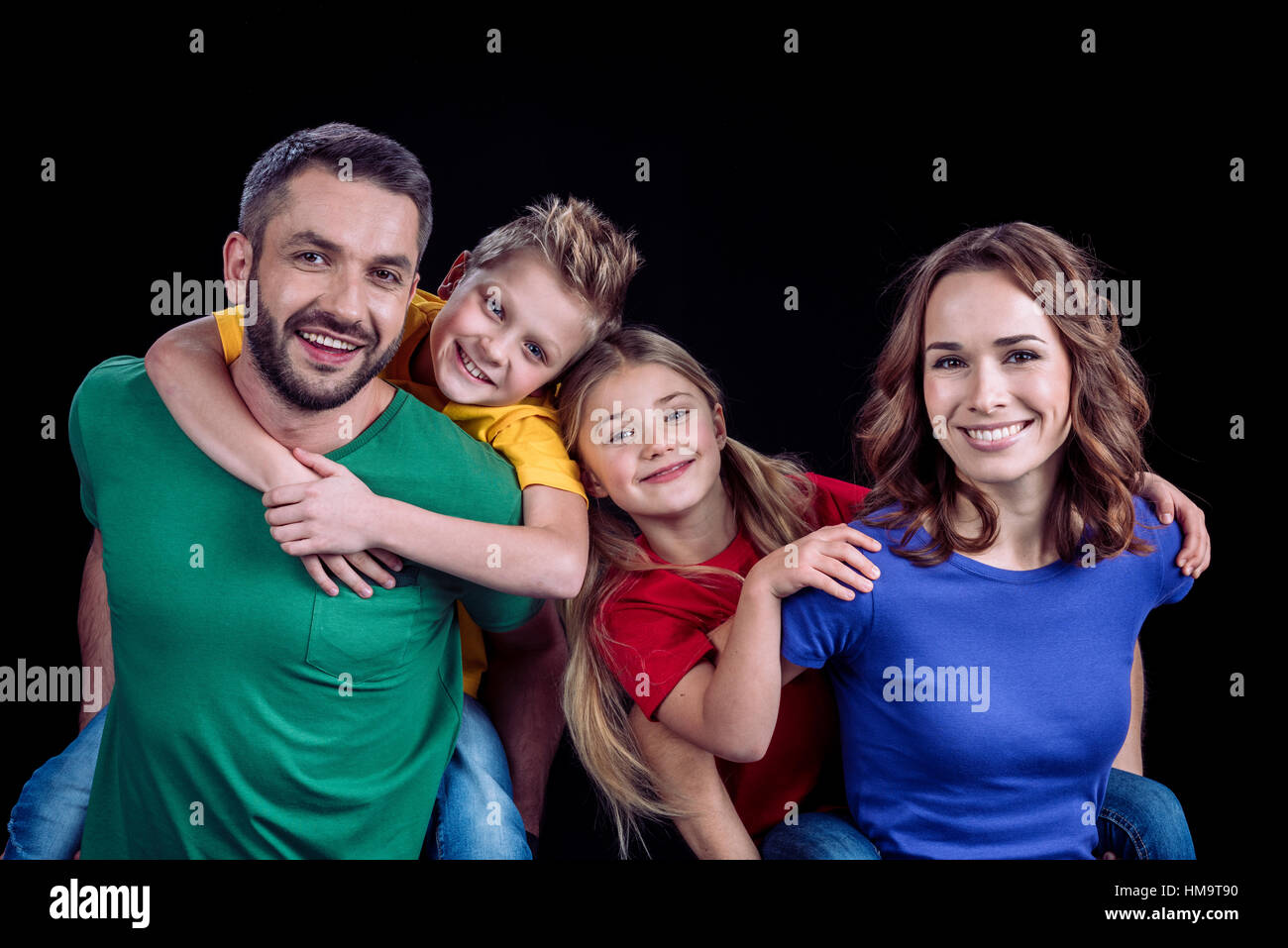Happy family smiling at camera Stock Photo