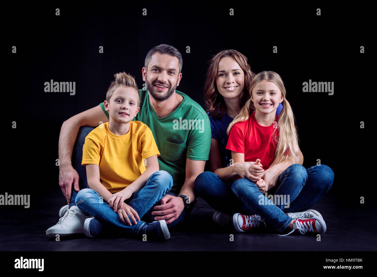 Happy family sitting together Stock Photo