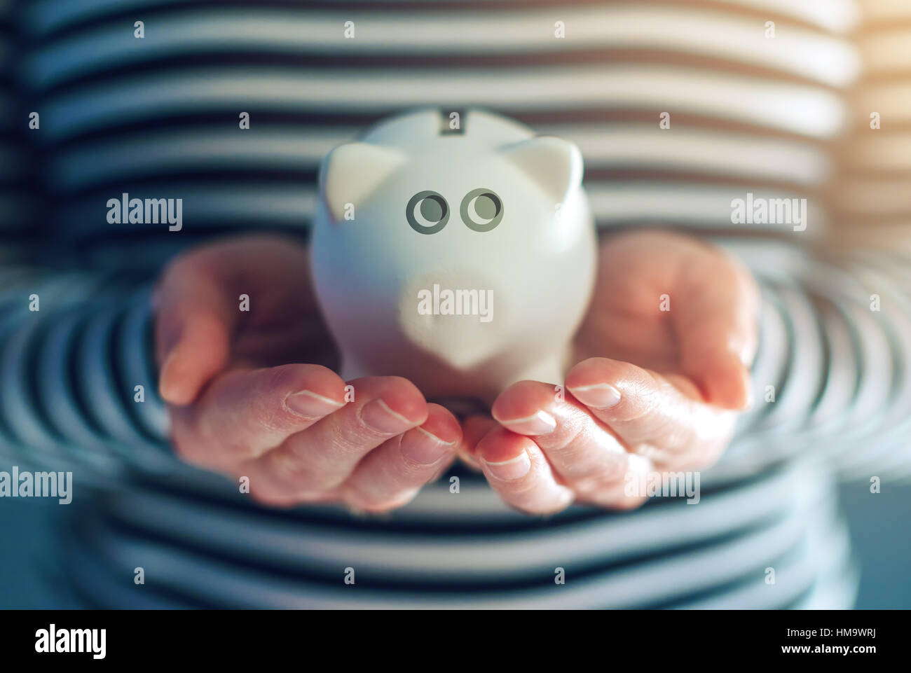 Home budget concept with piggy coin bank in female hands Stock Photo
