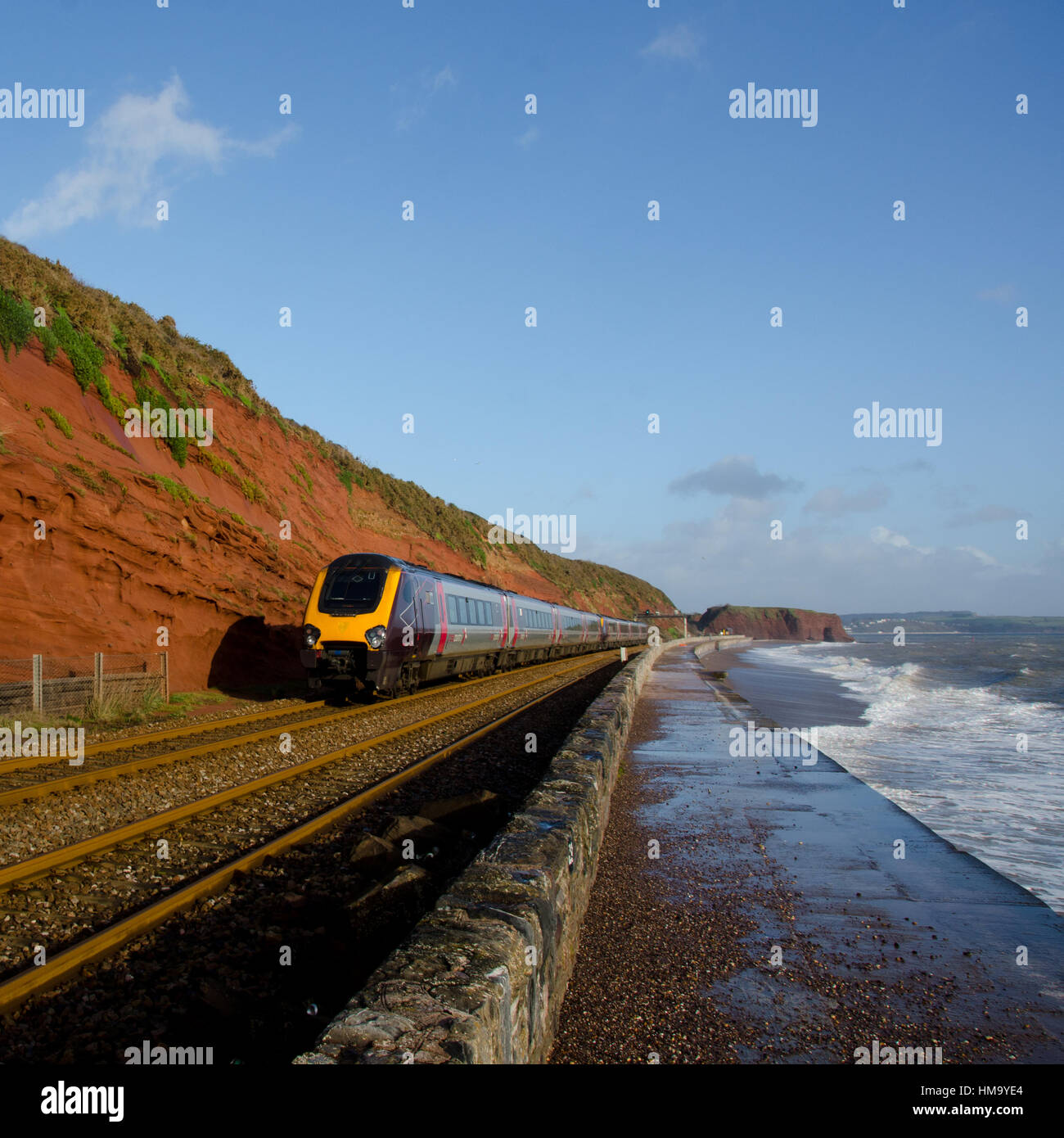 An Arriva Cross Country Class 220 Voyager High Speed Train between Dawlish and Dawlish Warren.  In the bacjground is Langstone Rock. Stock Photo